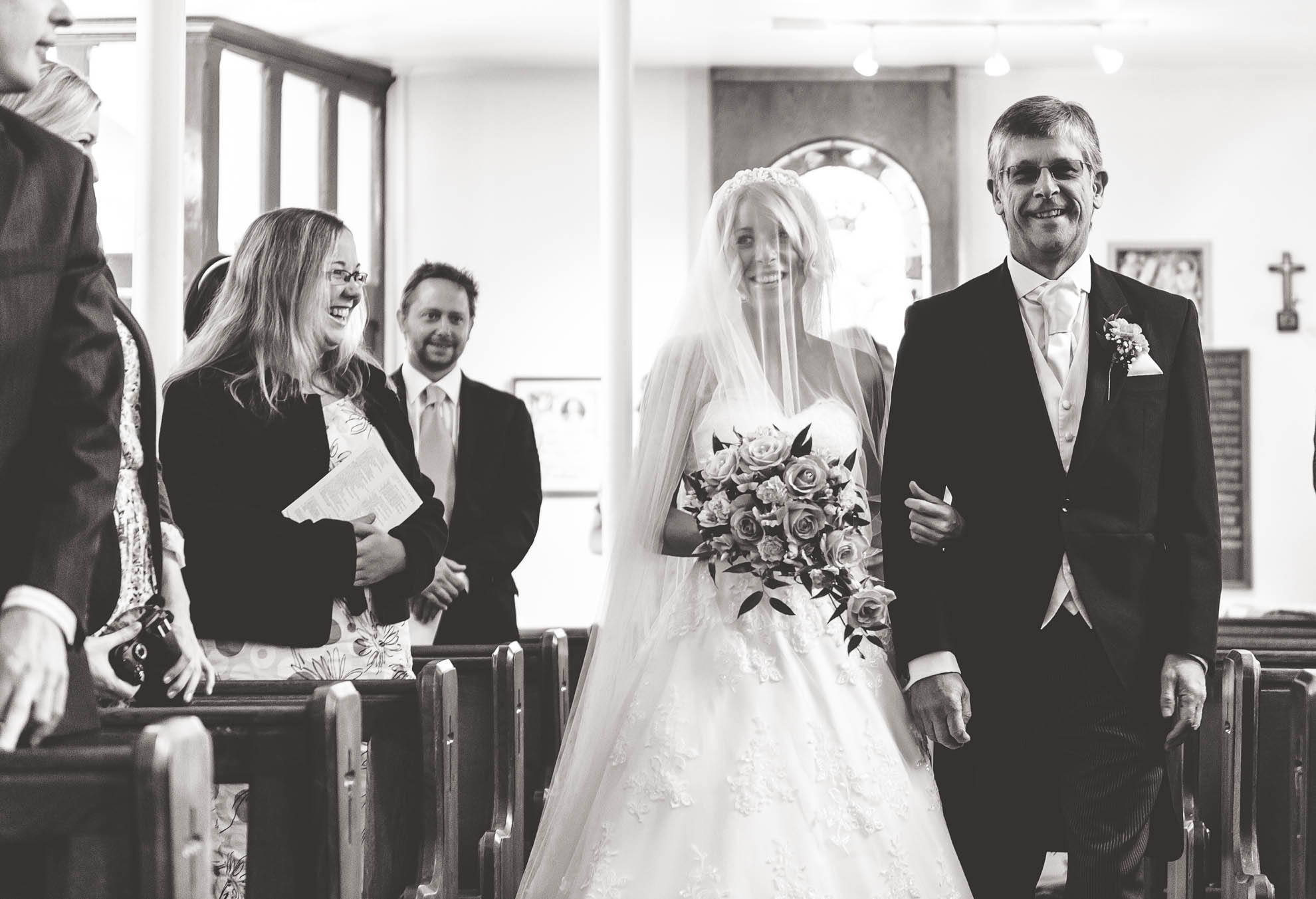 bride walks up aisle with her father