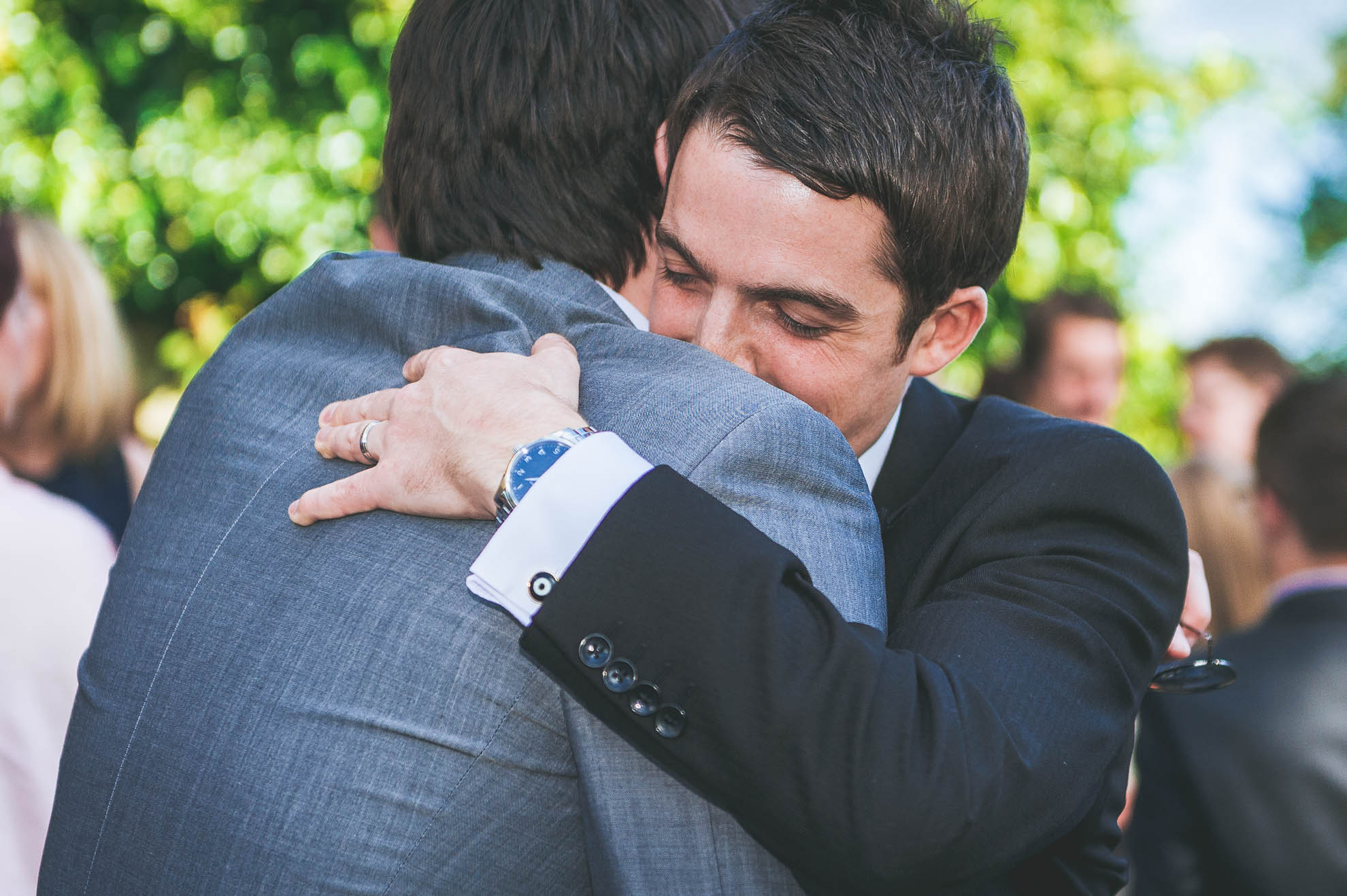 Groom hugging guest