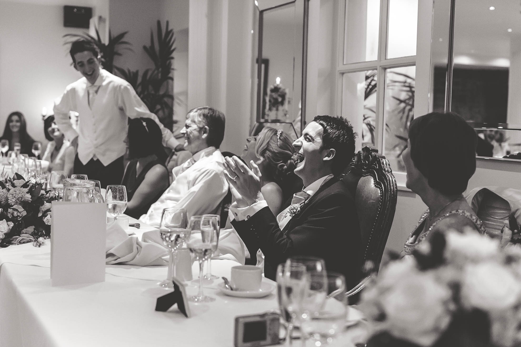 Groom laughs at best mans joke during speeches