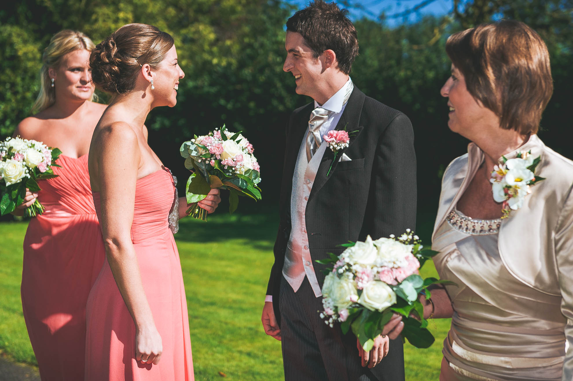 groom smiles at bridesmaid
