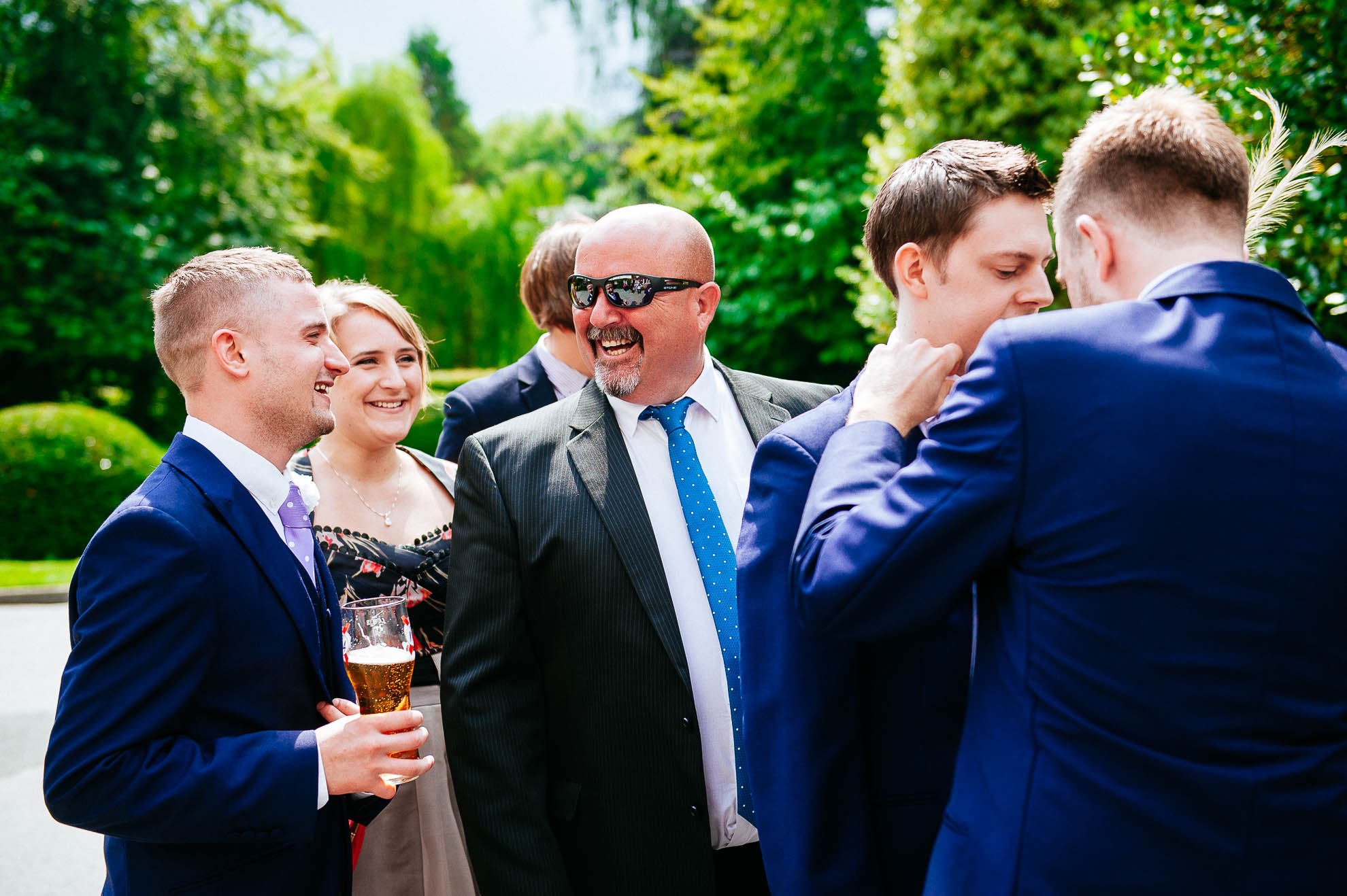 Wedding guest shares a joke with usher