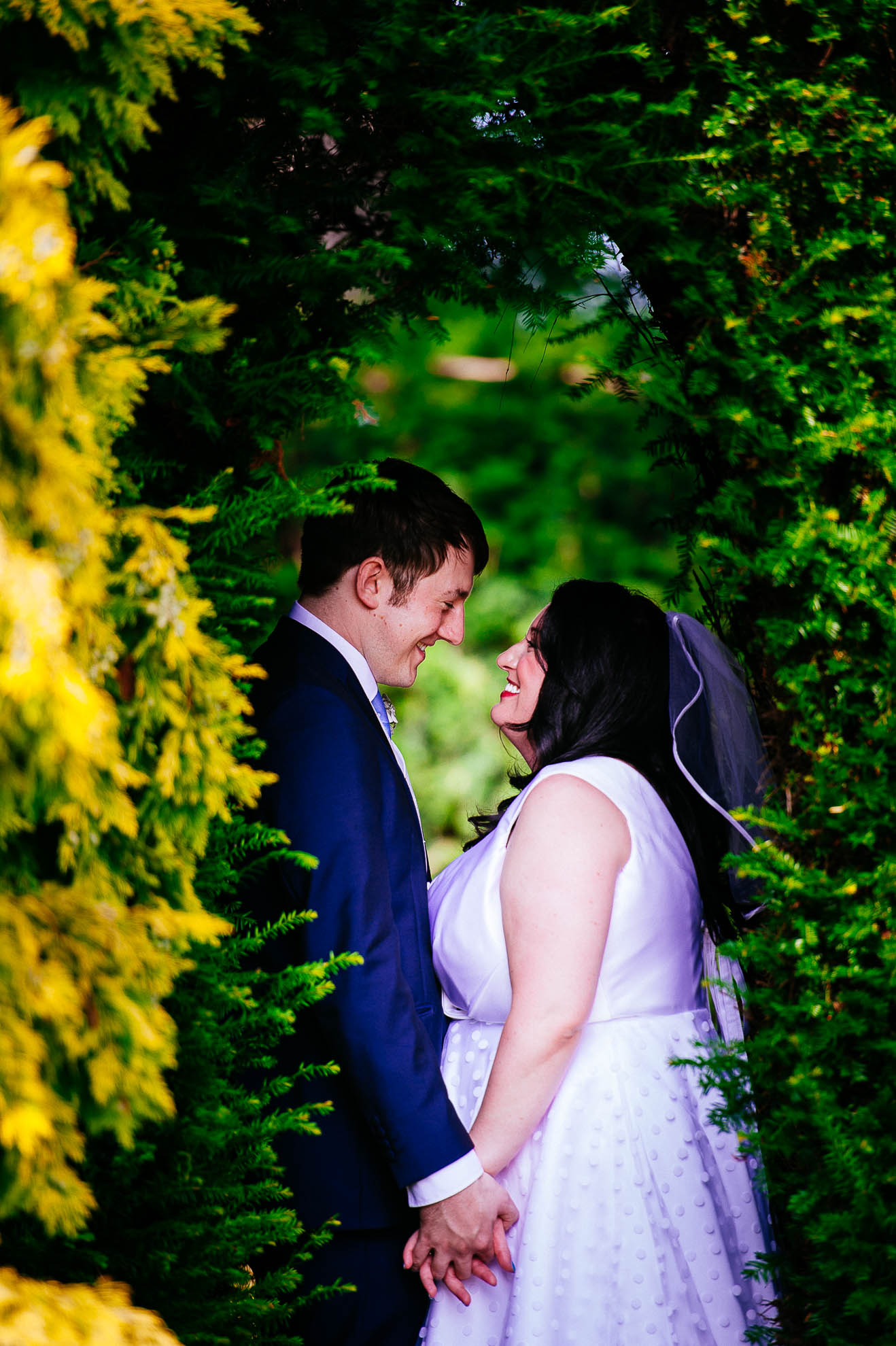 Bride and groom hold hands 