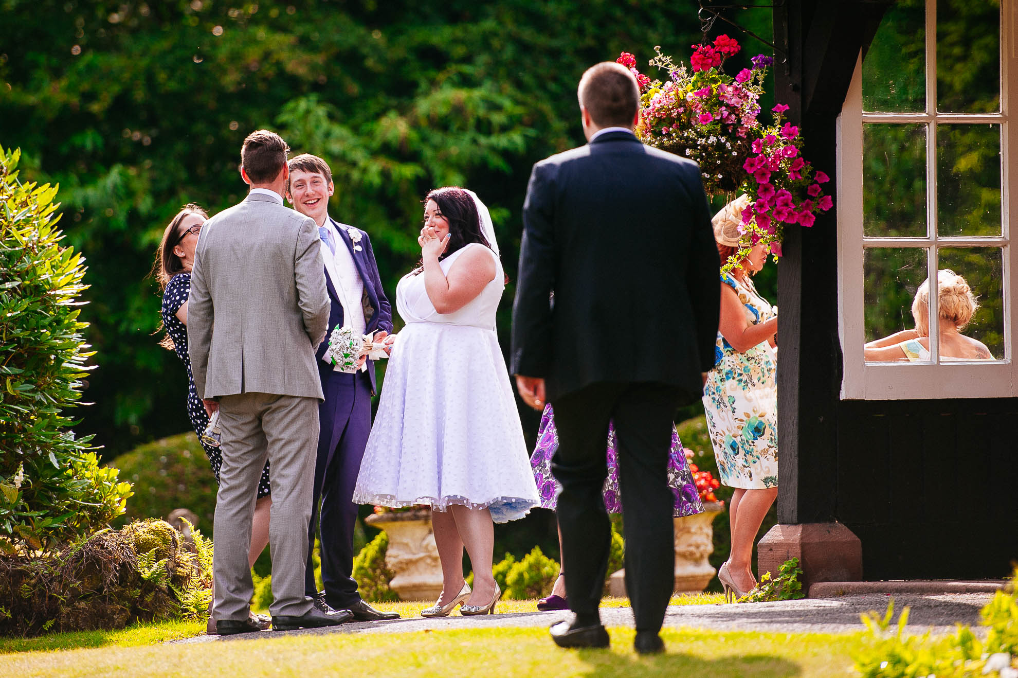 Bride and groom share a joke with guests