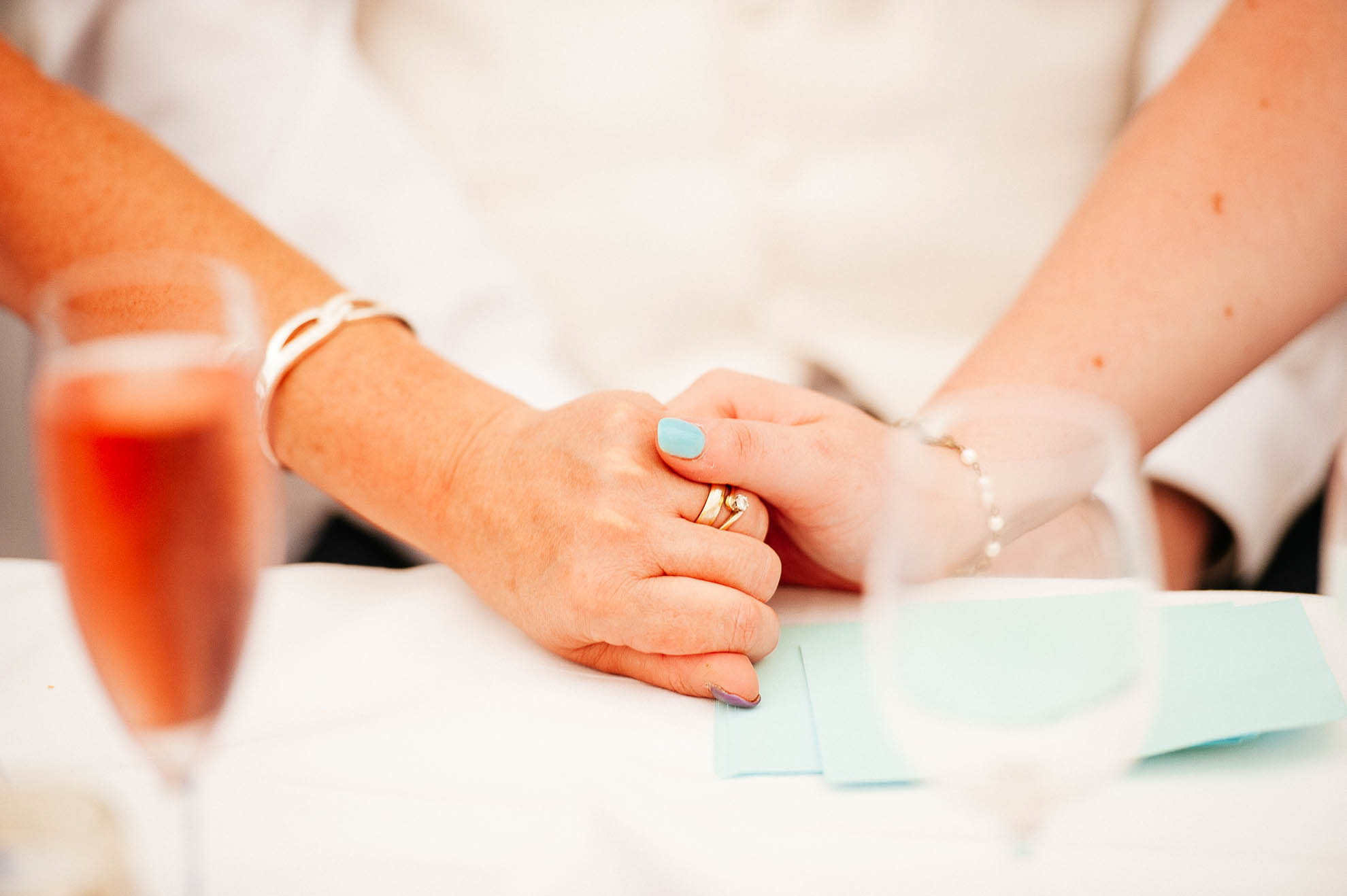 Bride and mother of the bride hold hands