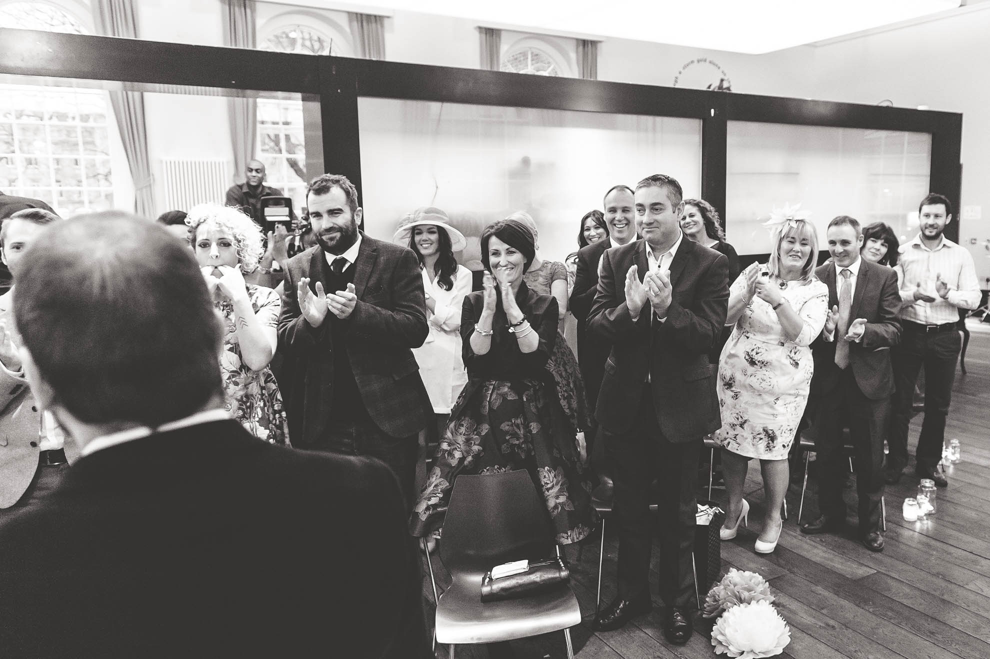 Guests cheer happy couple
