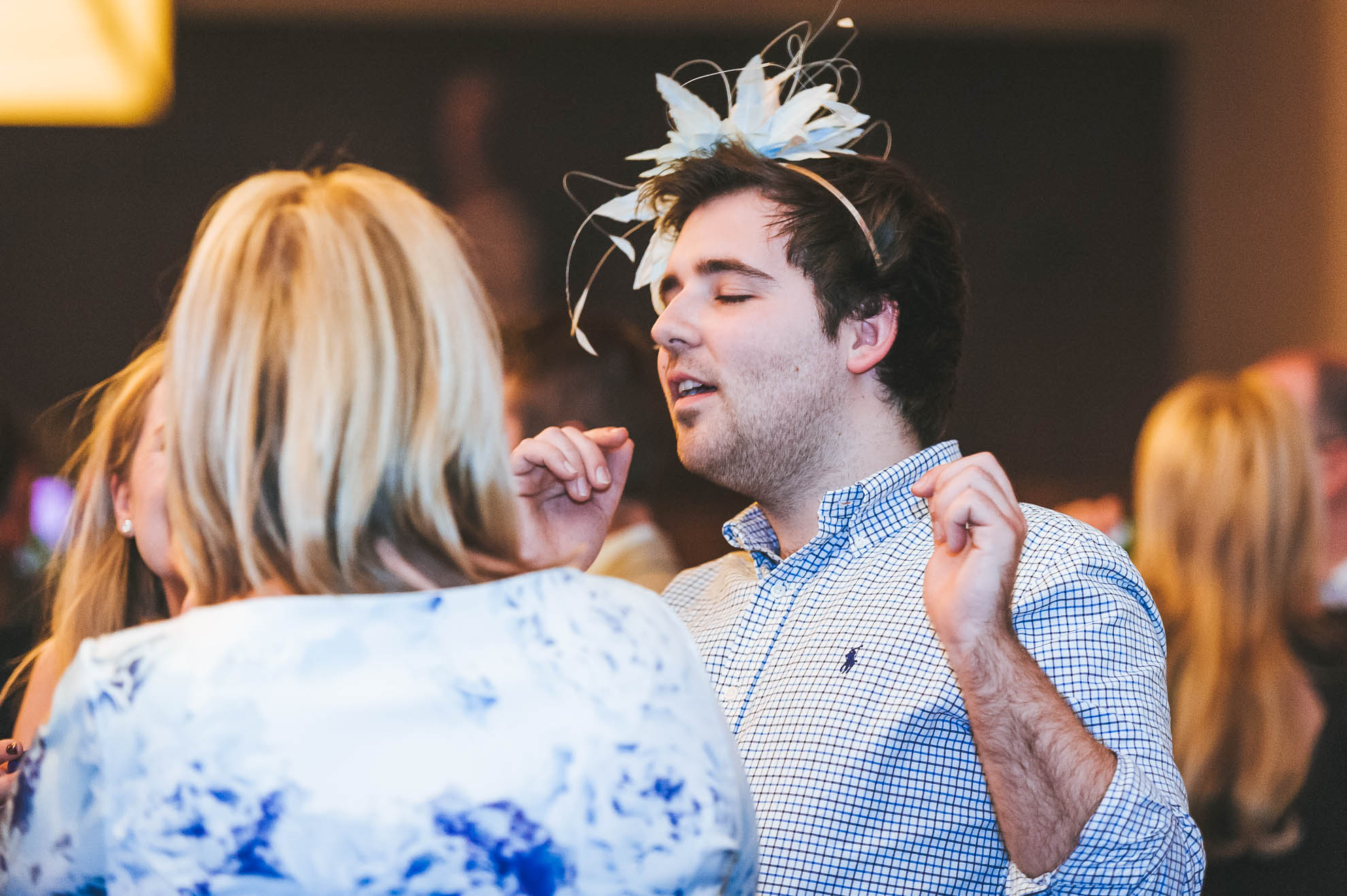 a man singing with woman's hat on