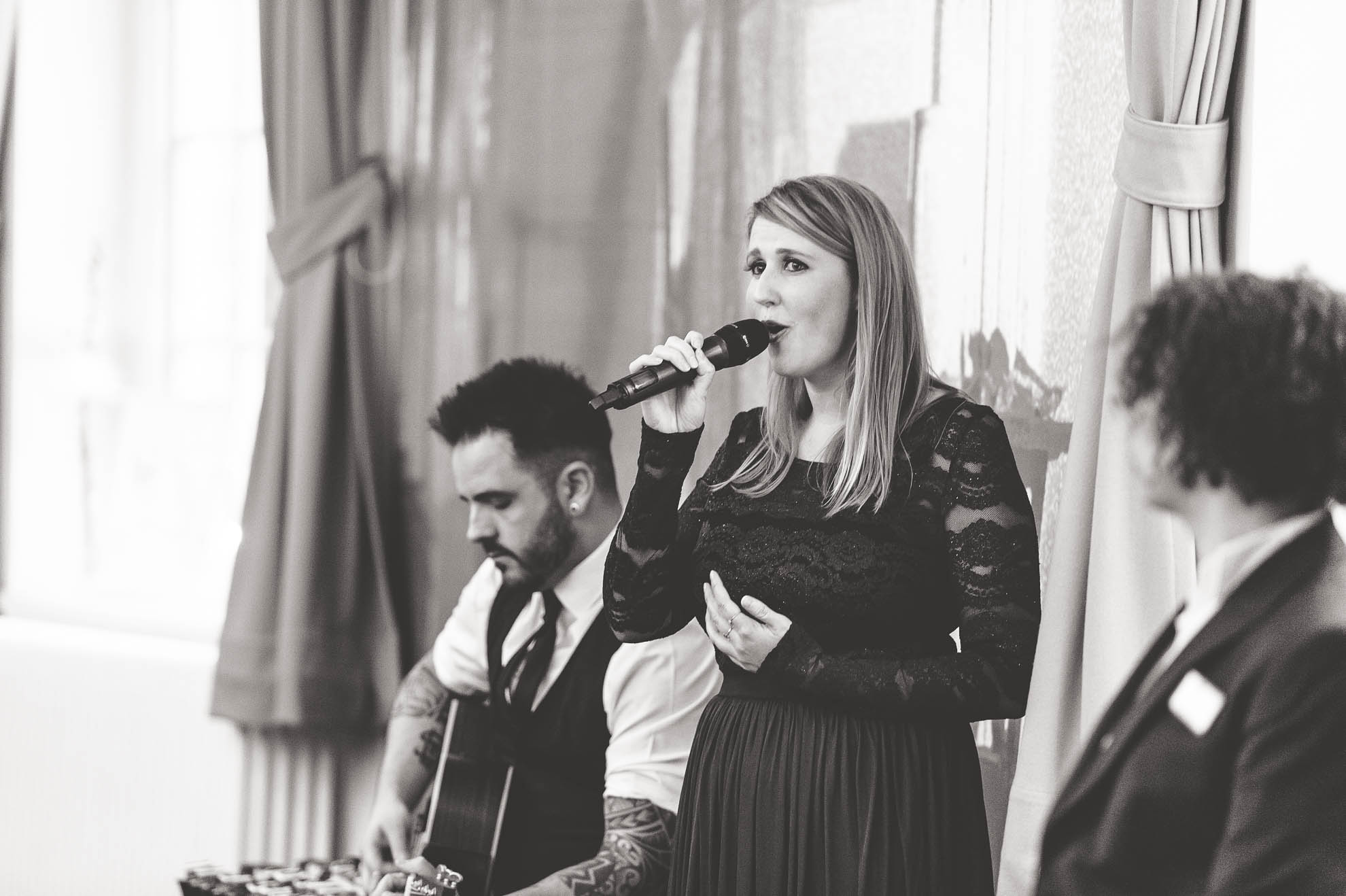 Guest sings as grooms enter the room