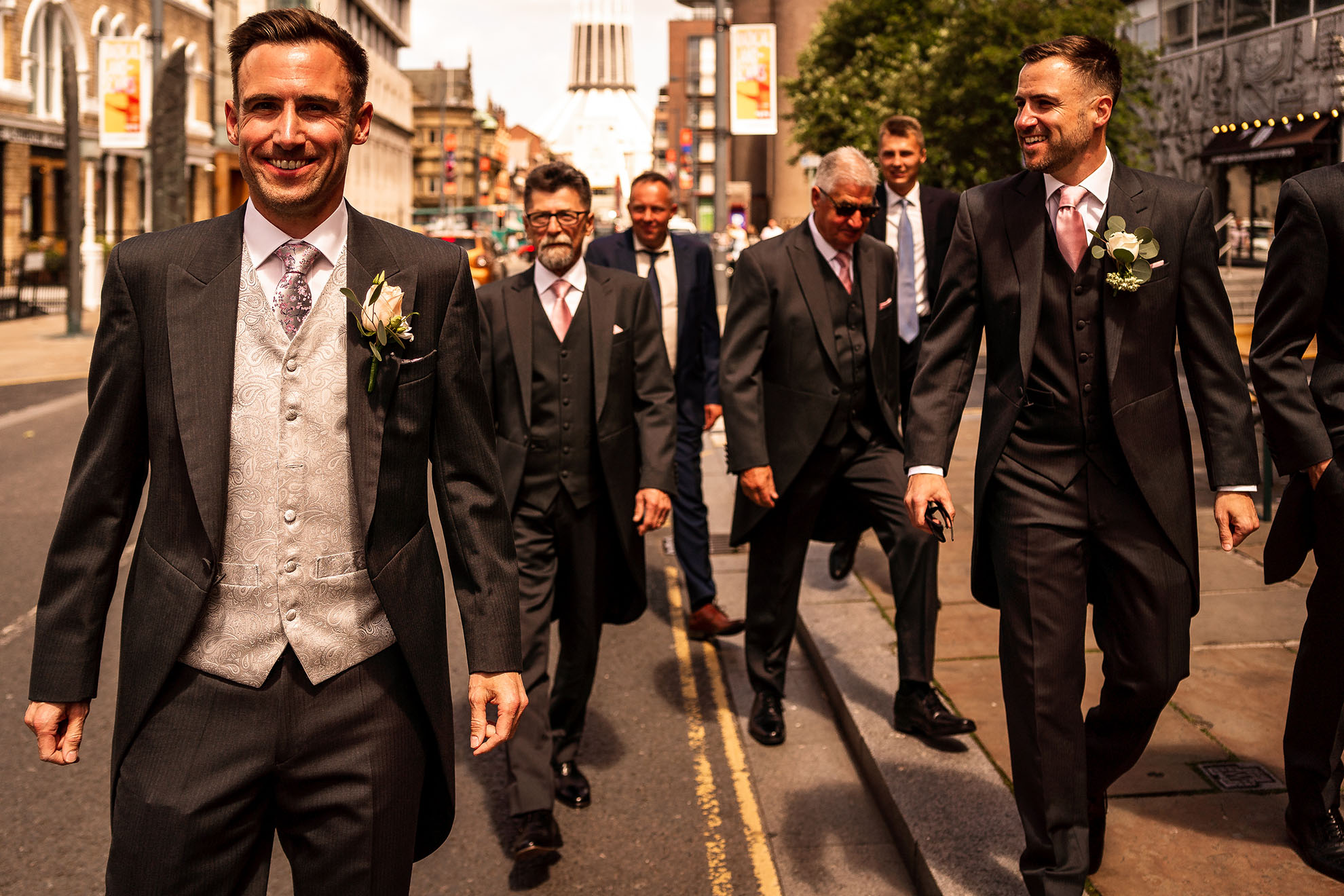 Groom amd his groomsmen walk up Hope Street.