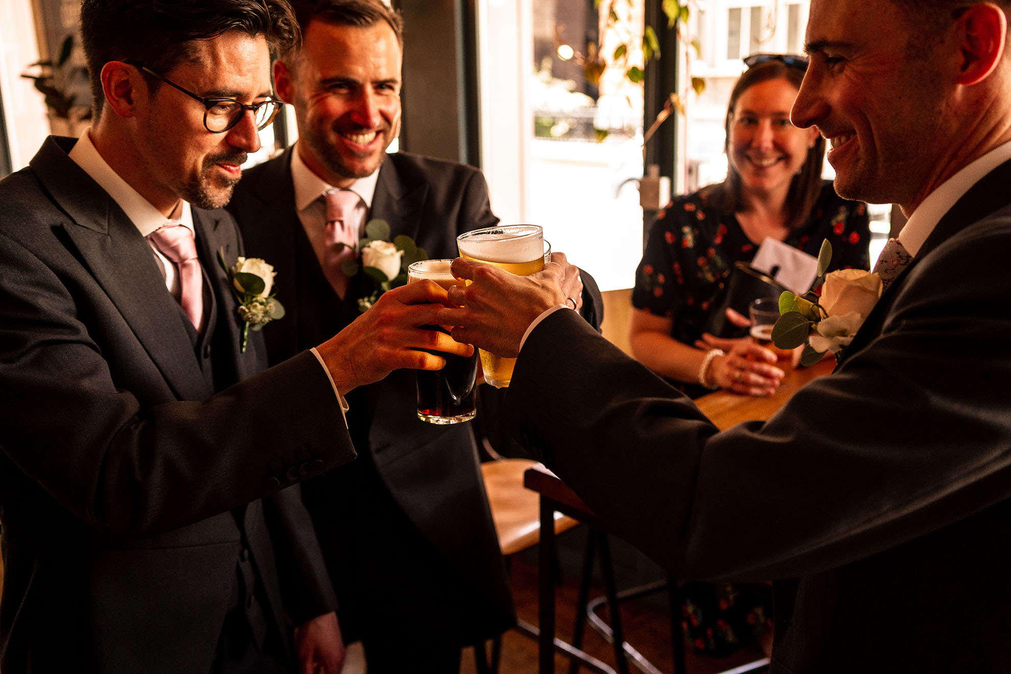 Groom and groomsmen have a drink of beer