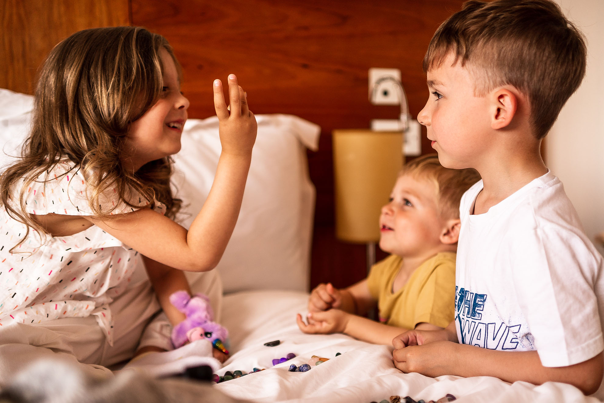 Flower girl plays with page boys