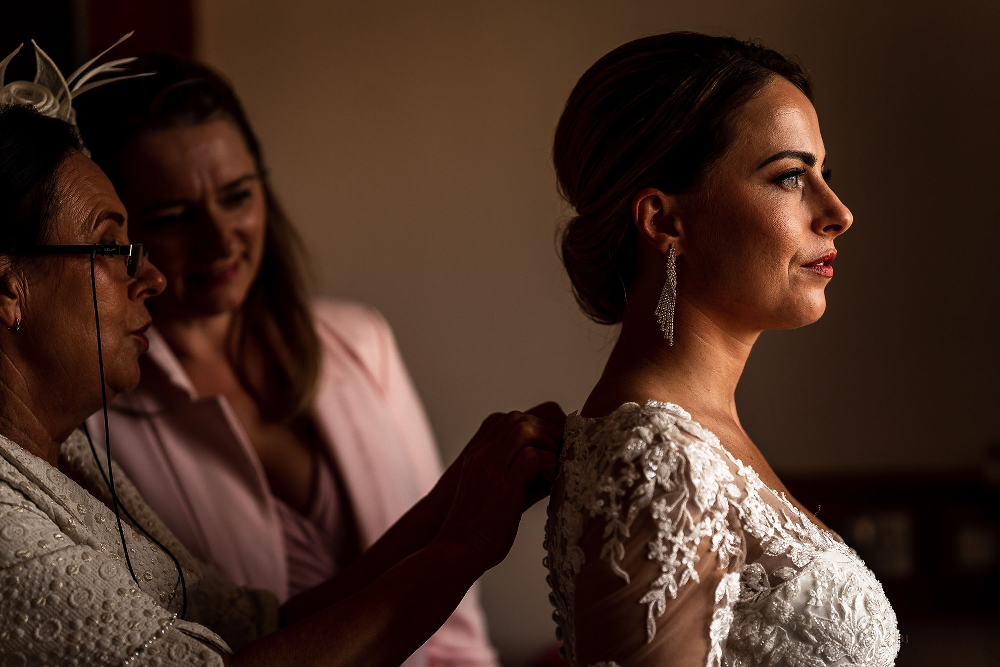 bride puts on her wedding dress