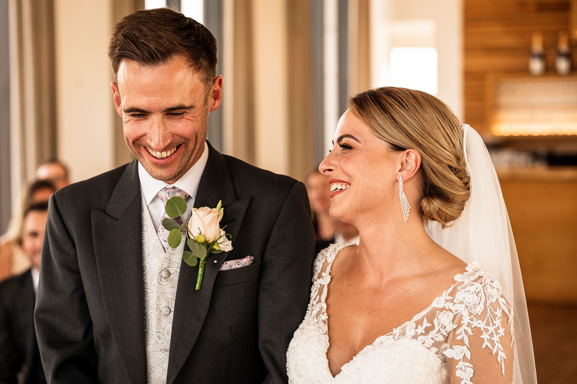 Bride and grrom share a joke during the wedding ceremony