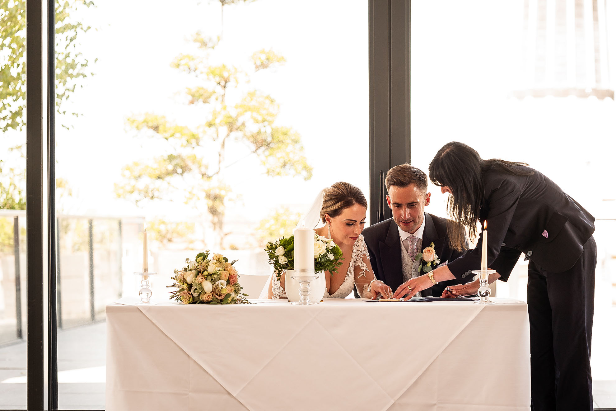 Bride and groom sign the register
