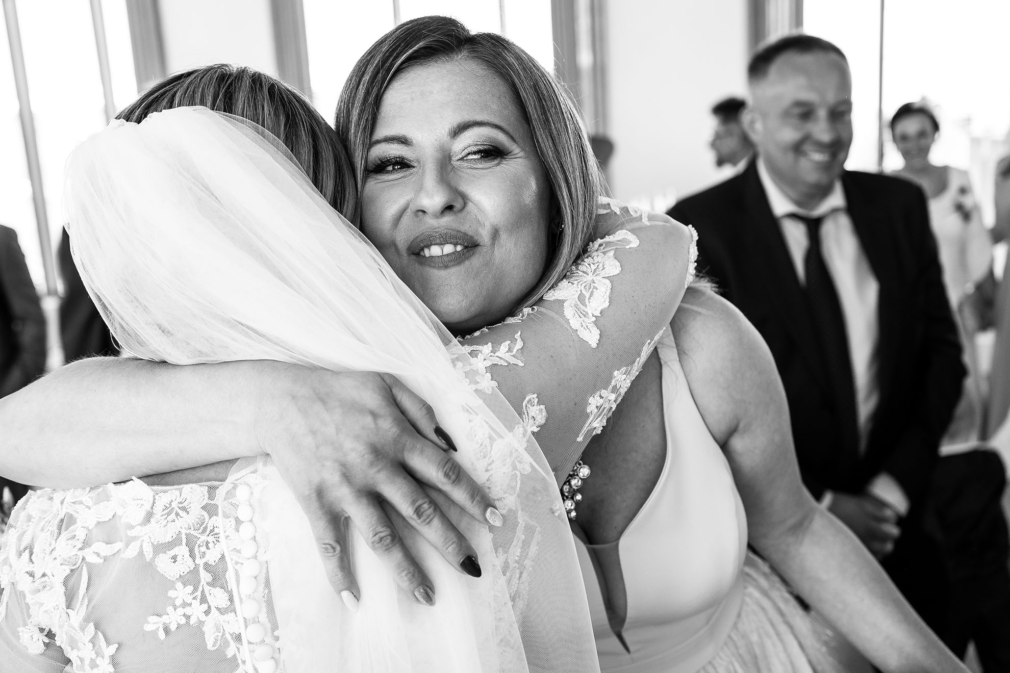 Brides sister hugs bride