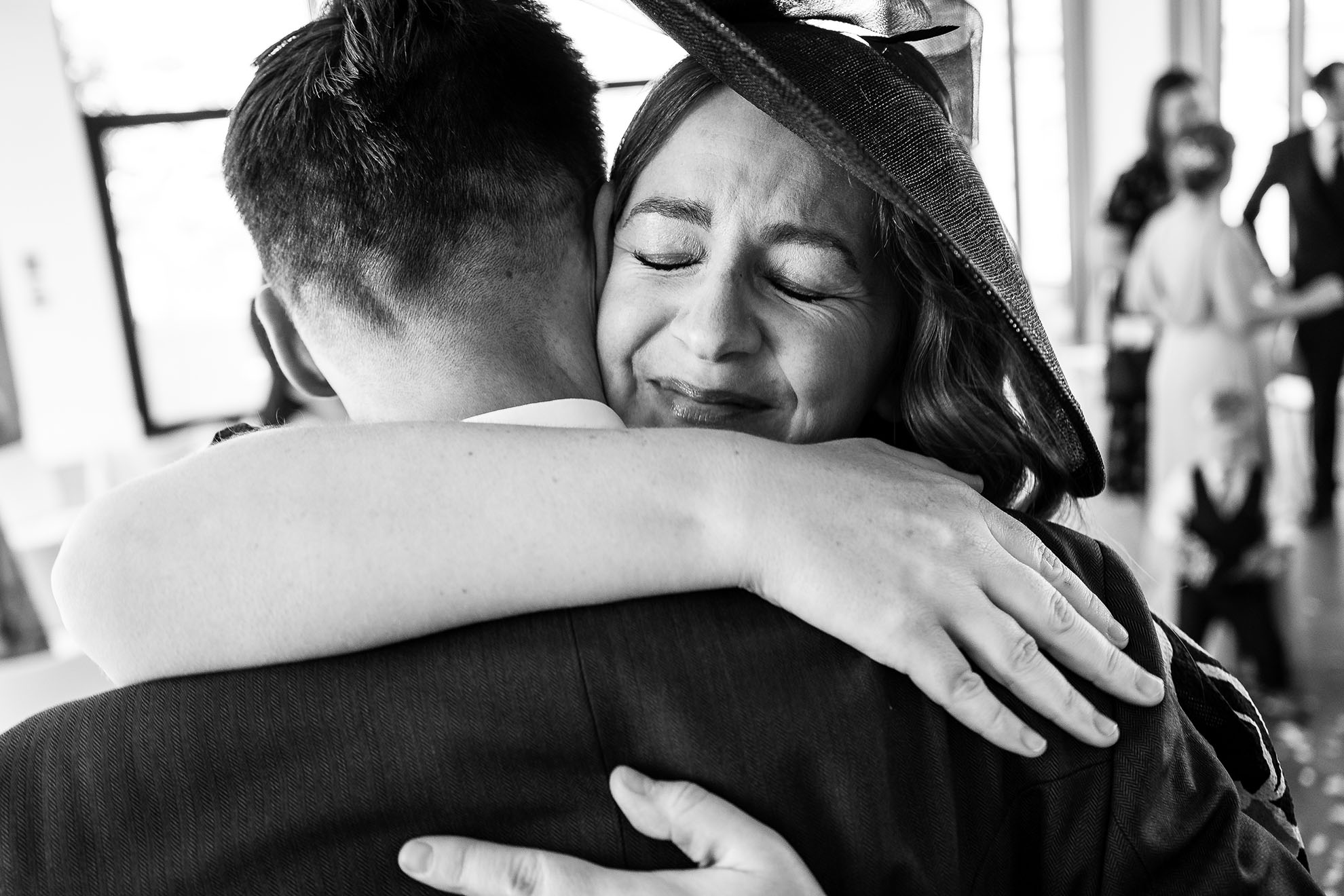 Wedding guest hugs groom