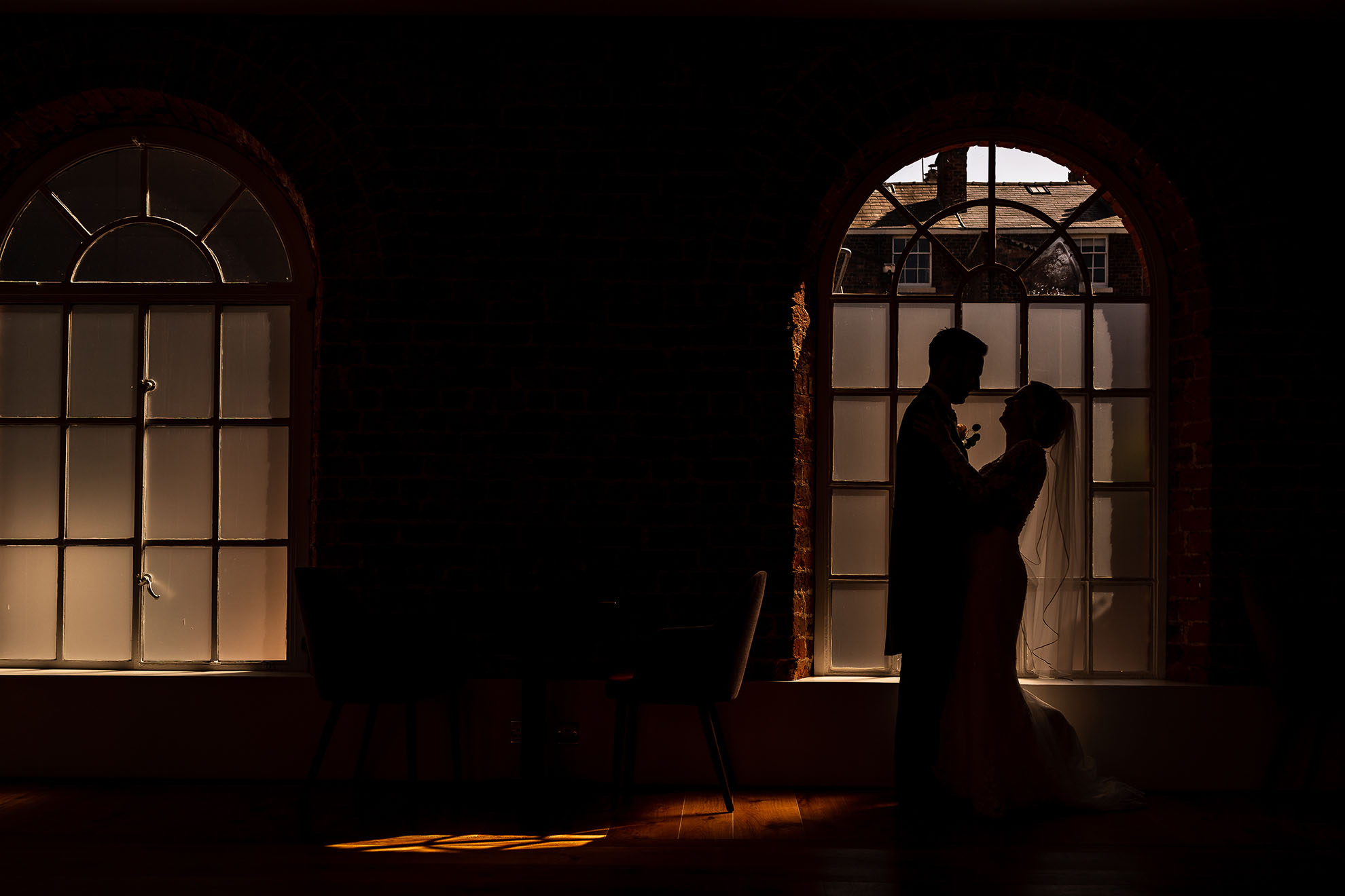 Bride and groom silouhette in window of Hope Street Hotel wedding venue
