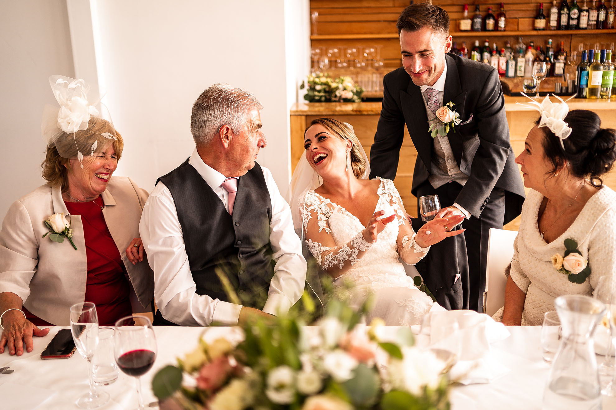 Bride snd groom joking with in-laws