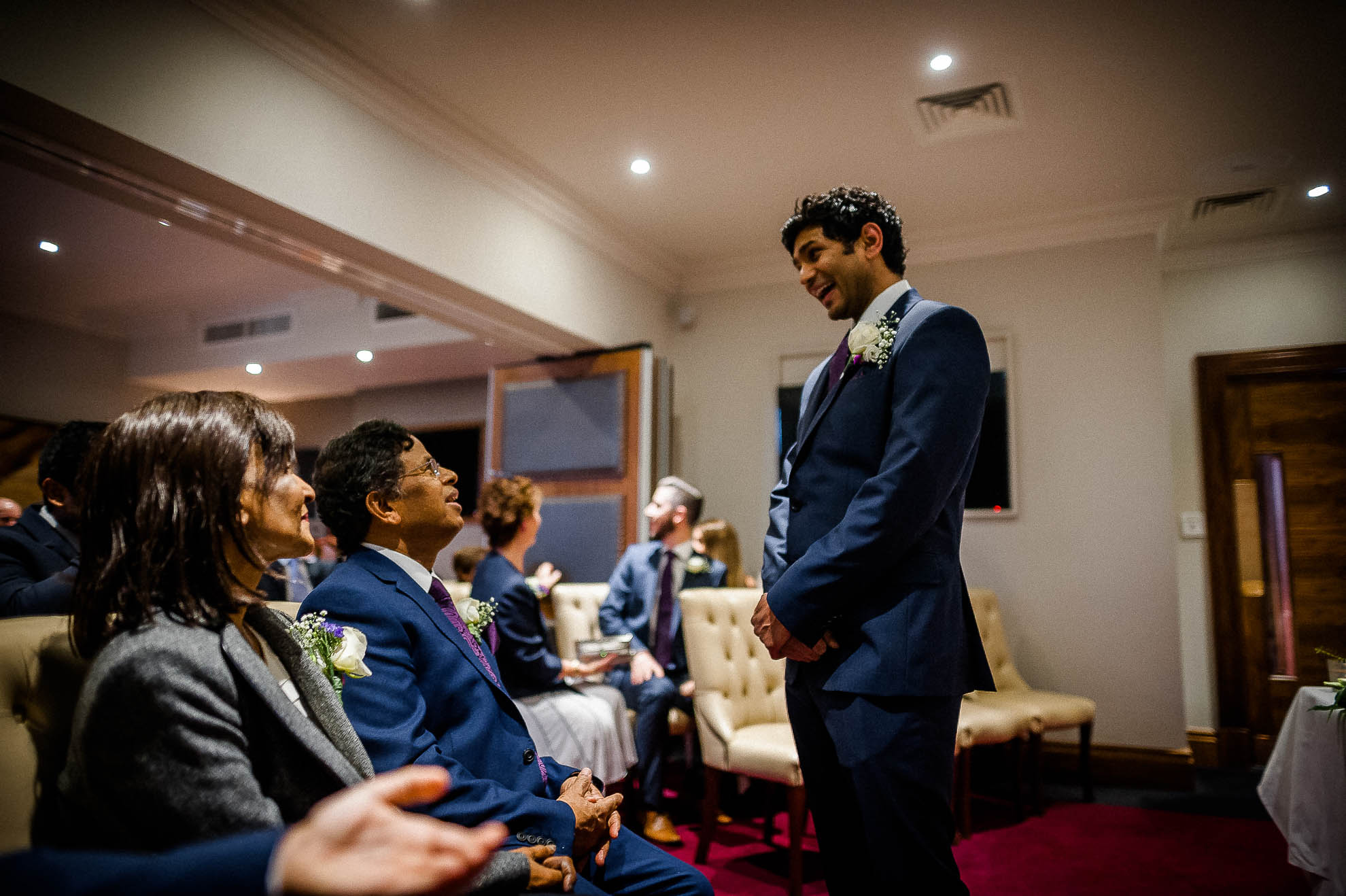 Groom shares a joke with his parents