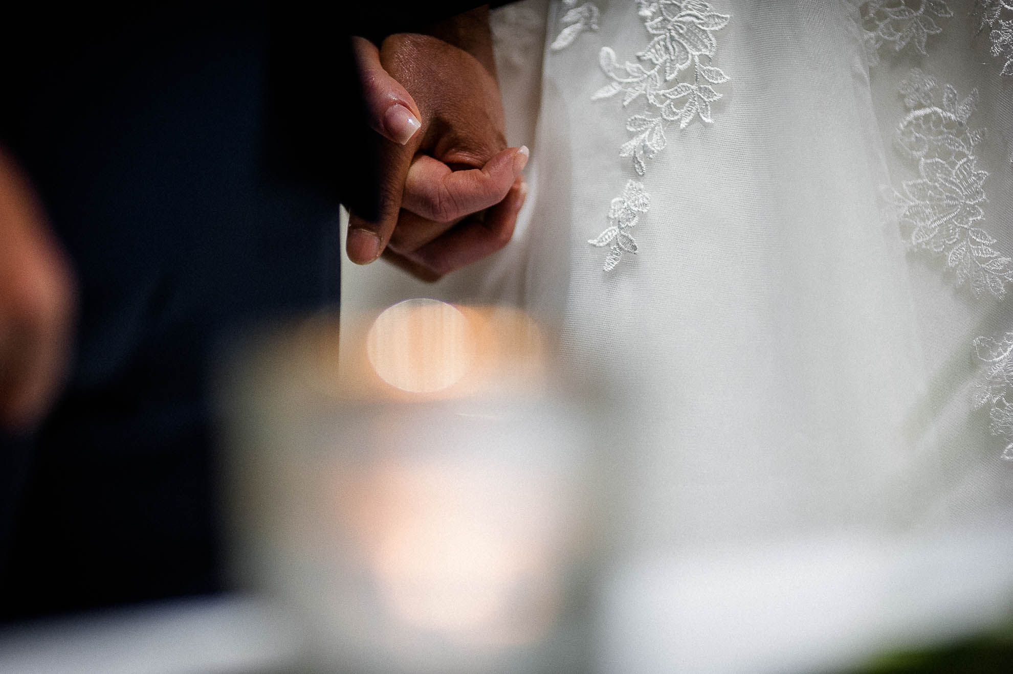 Bride and groom hold hands