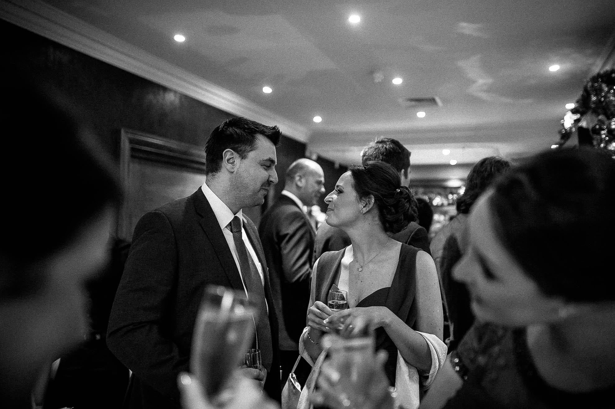 Bridesmaid and her partner share a joke