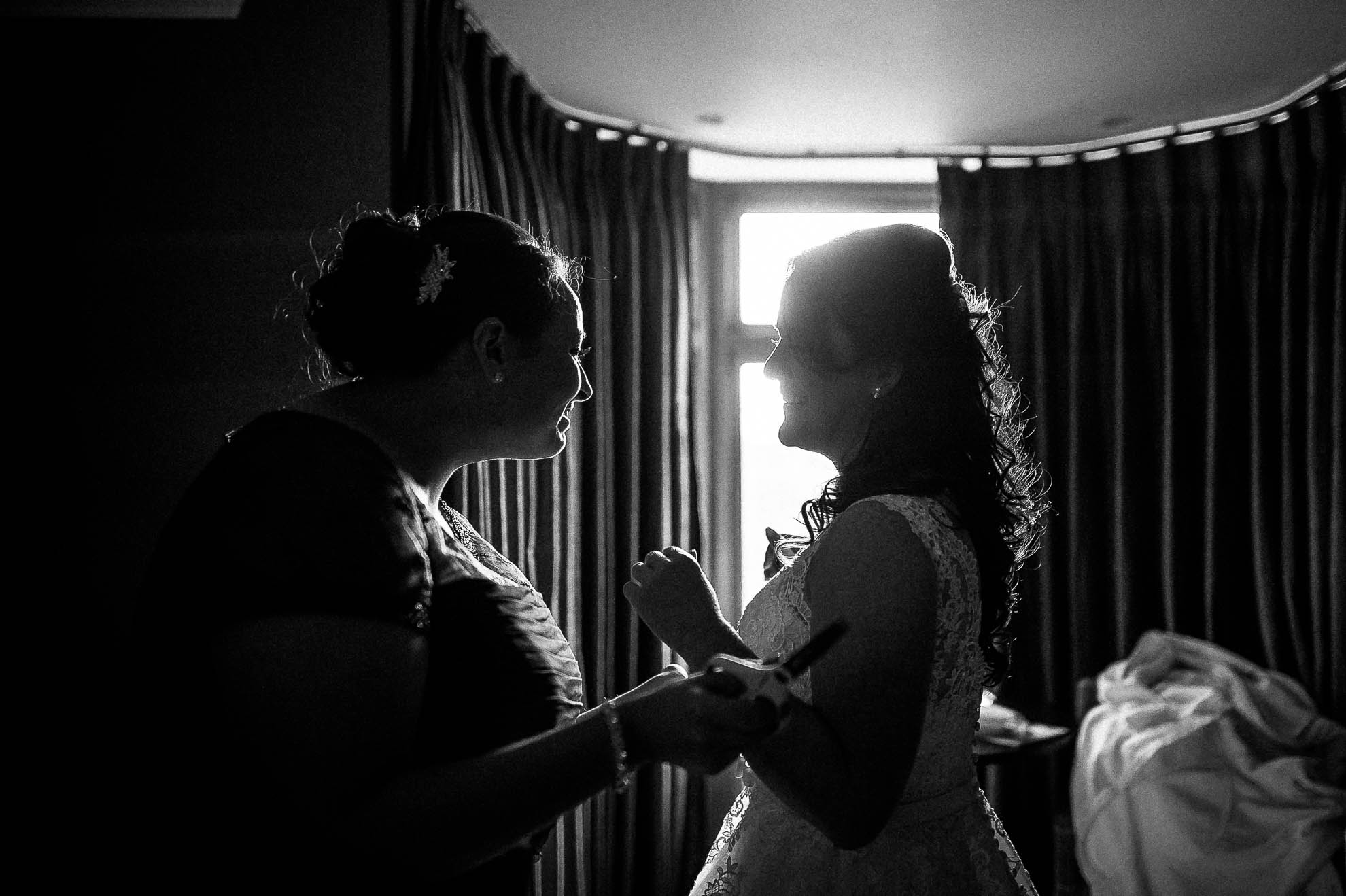 Bride shares a joke with her bridesmaid