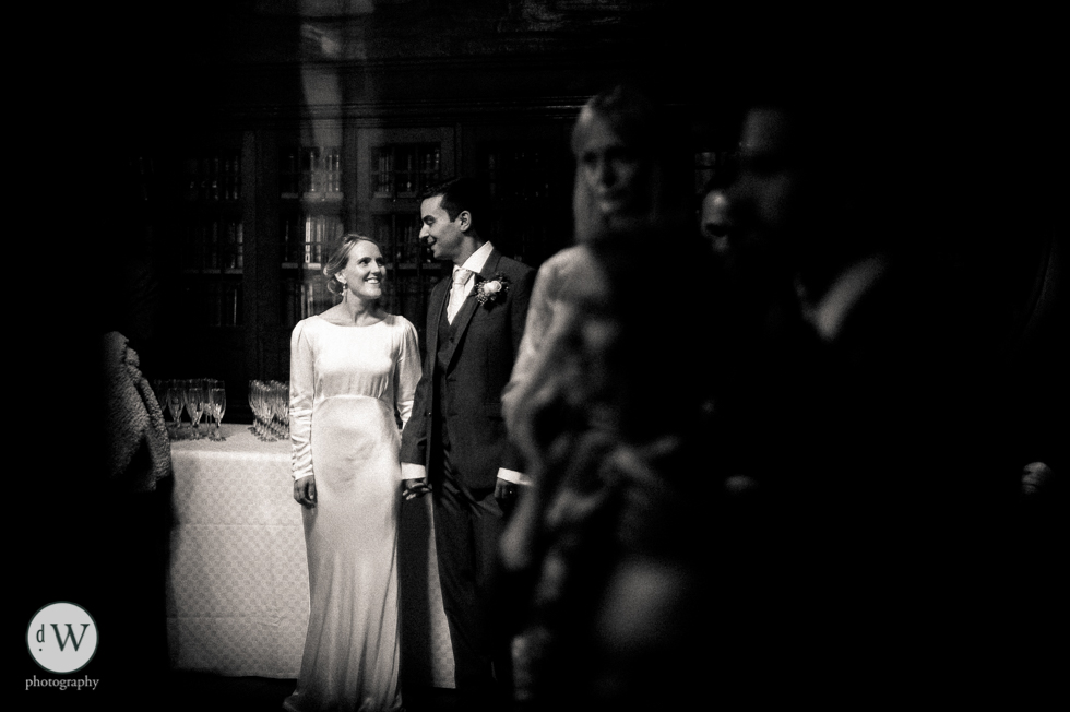 Bride and groom holding hands smiling