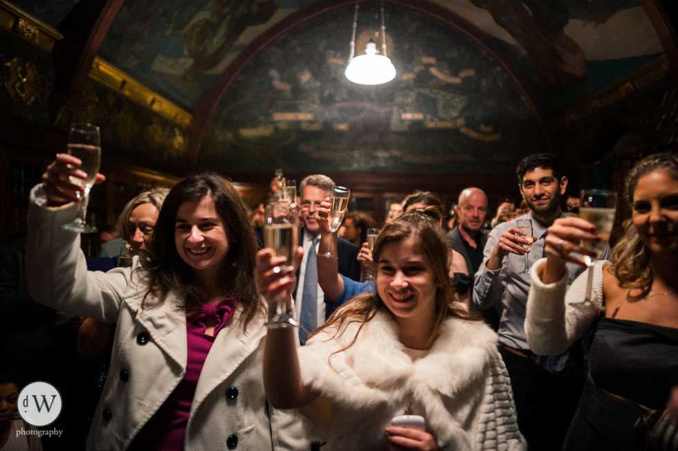 Wedding guests toast the bride and groom