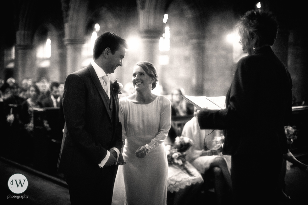Bride and groom smiling at each other during exchange of vows