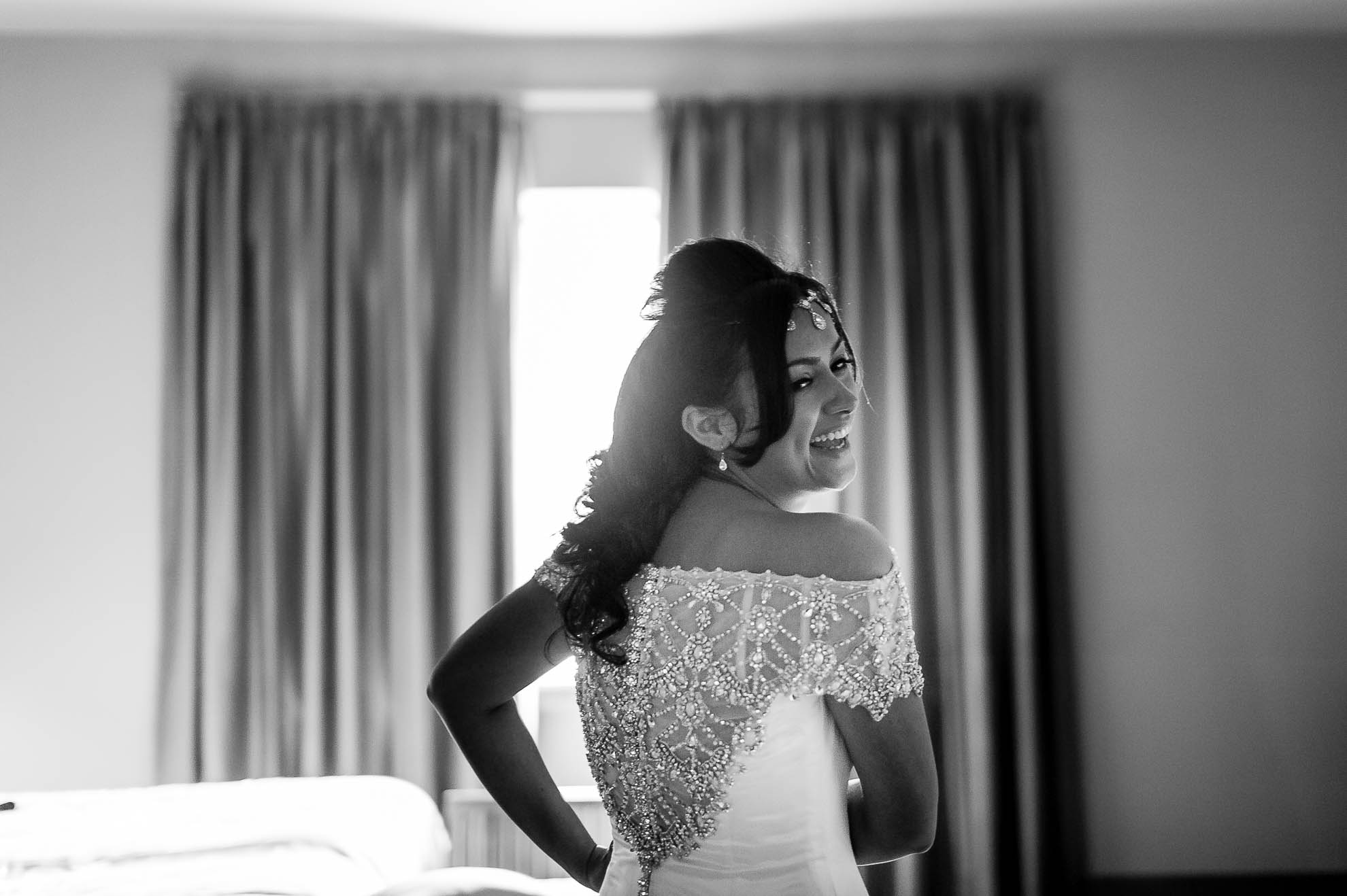 bride laughs in delight at bridesmaids reaction