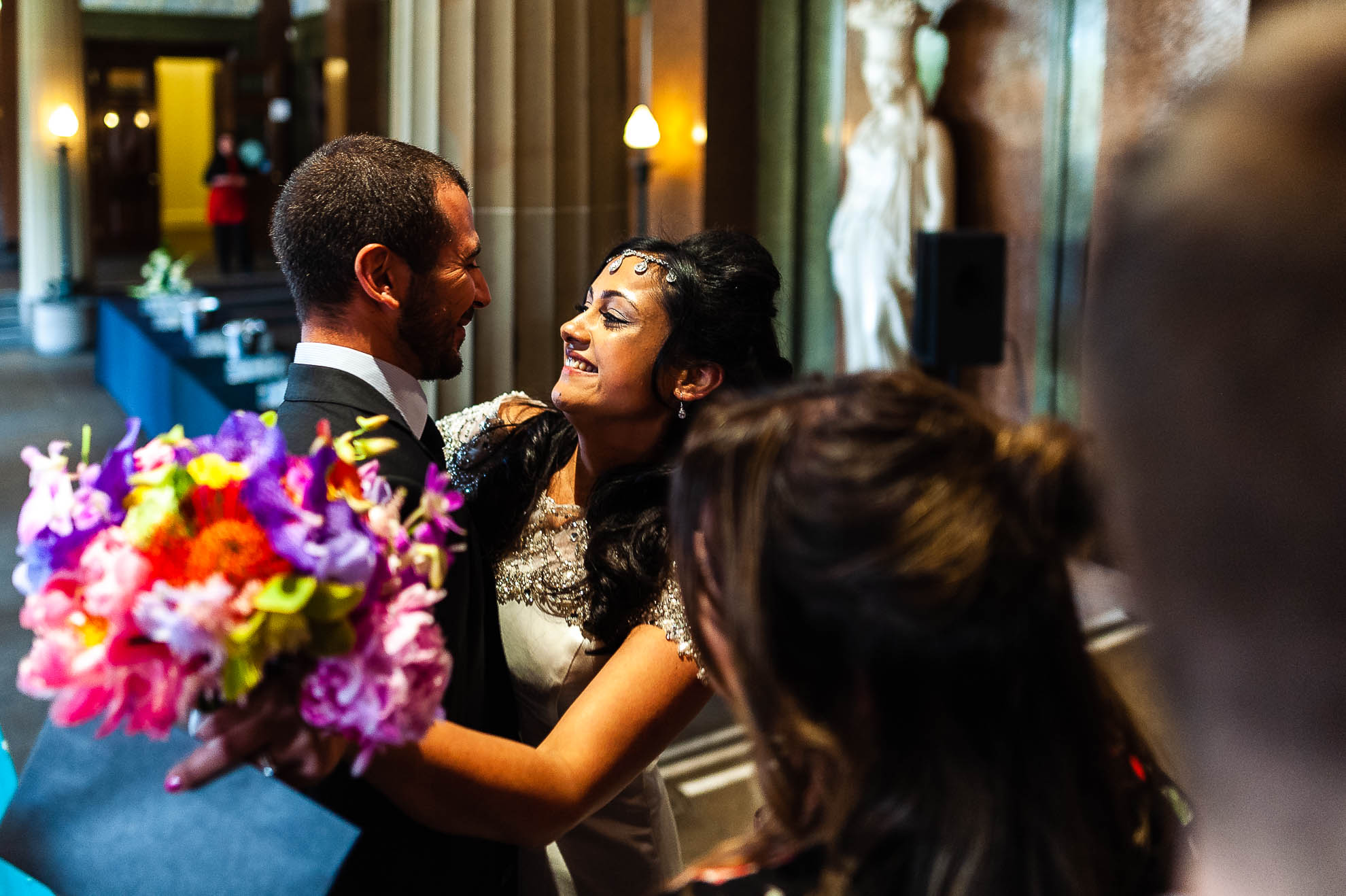 Bride is hugged and congratulated by a guest