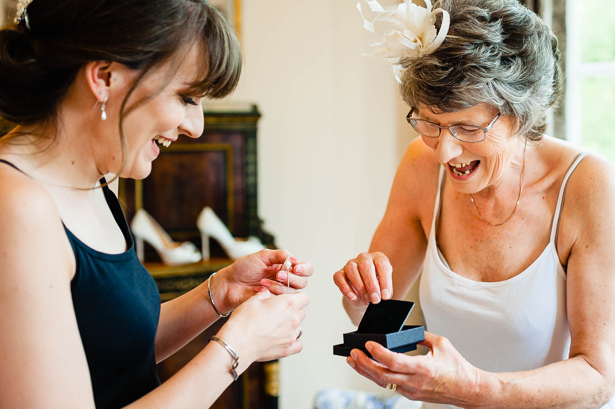 grooms mother opens her present and smiles