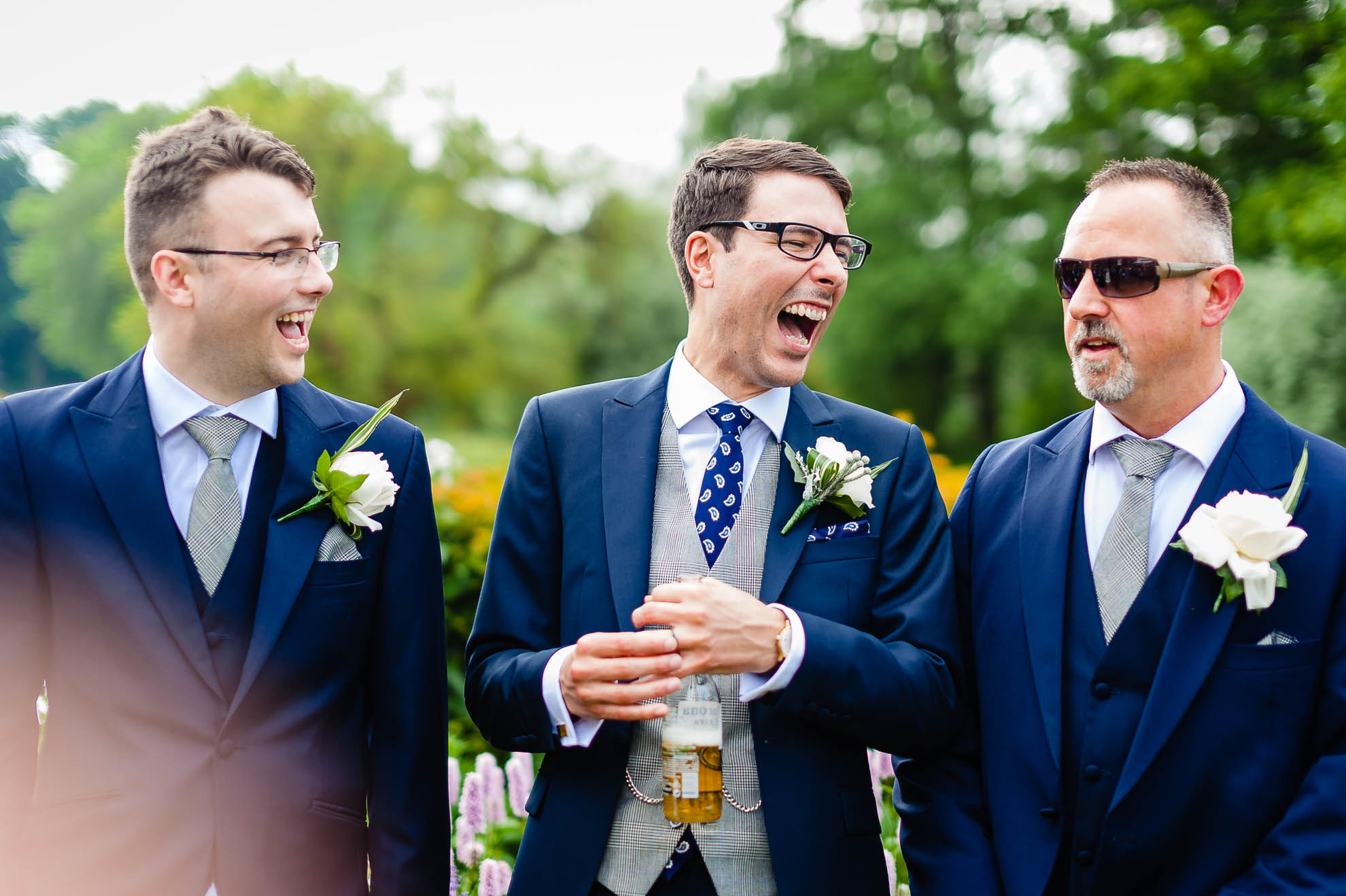 Groom shares a joke with a guest 