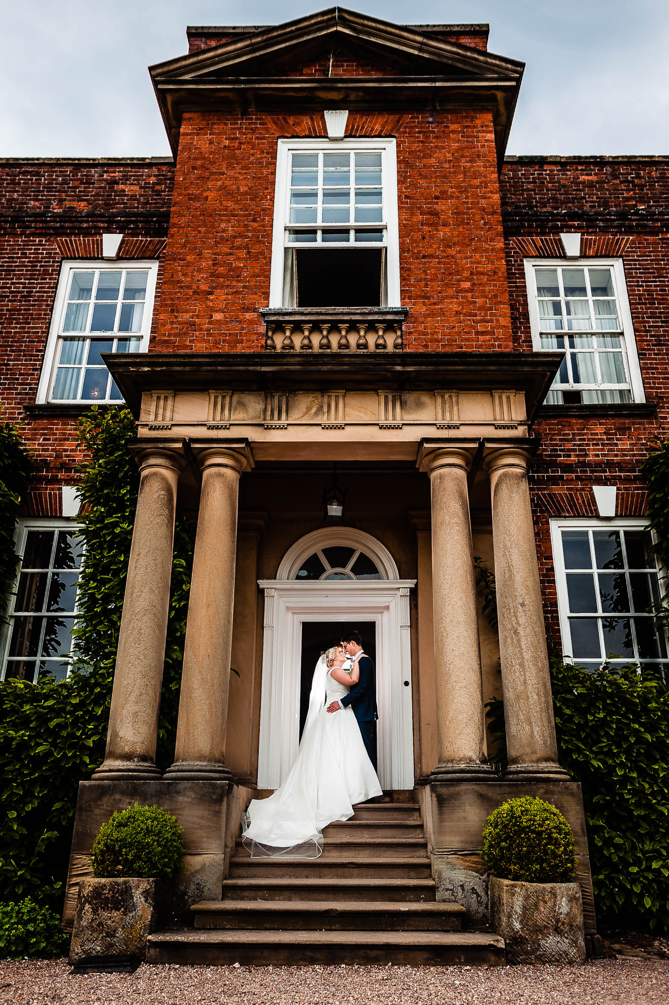 Bride and groom portrait at front door of Iscoyd Park