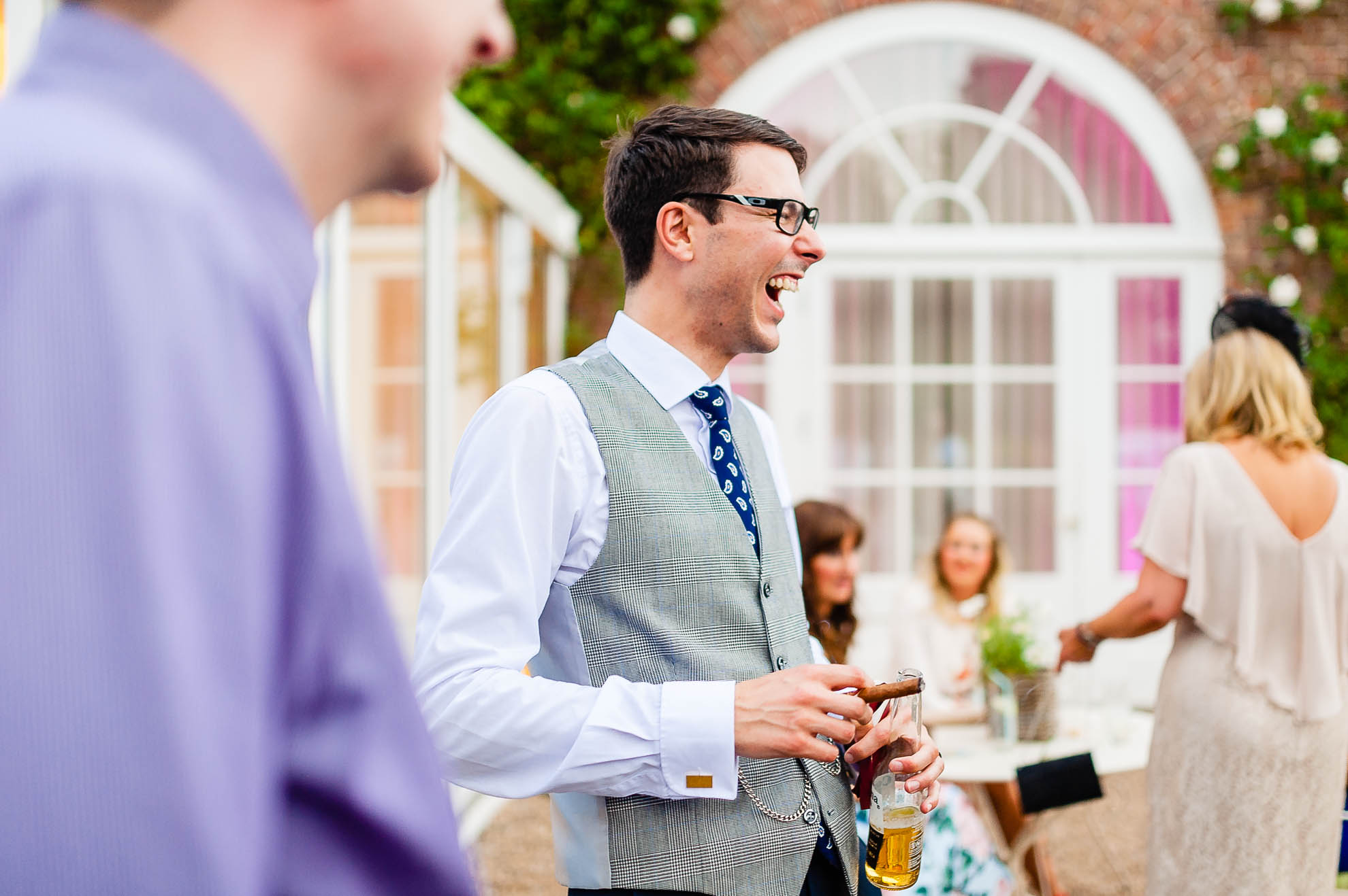 Groom shares a joke with a guest