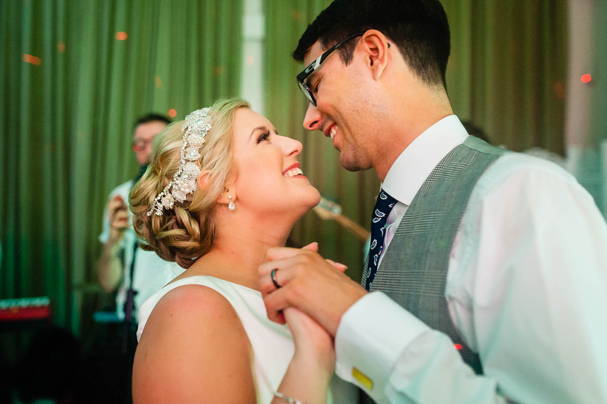 Happy couple smile as they dance the first dance