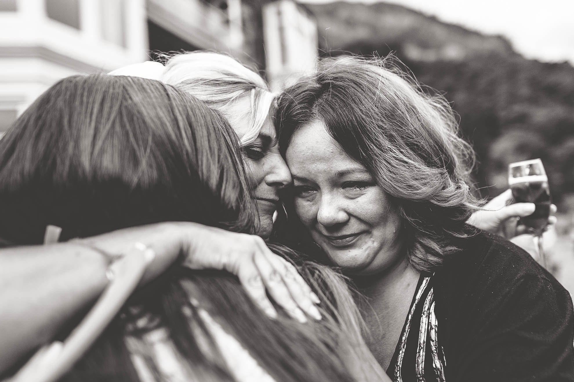 Guests hug bride
