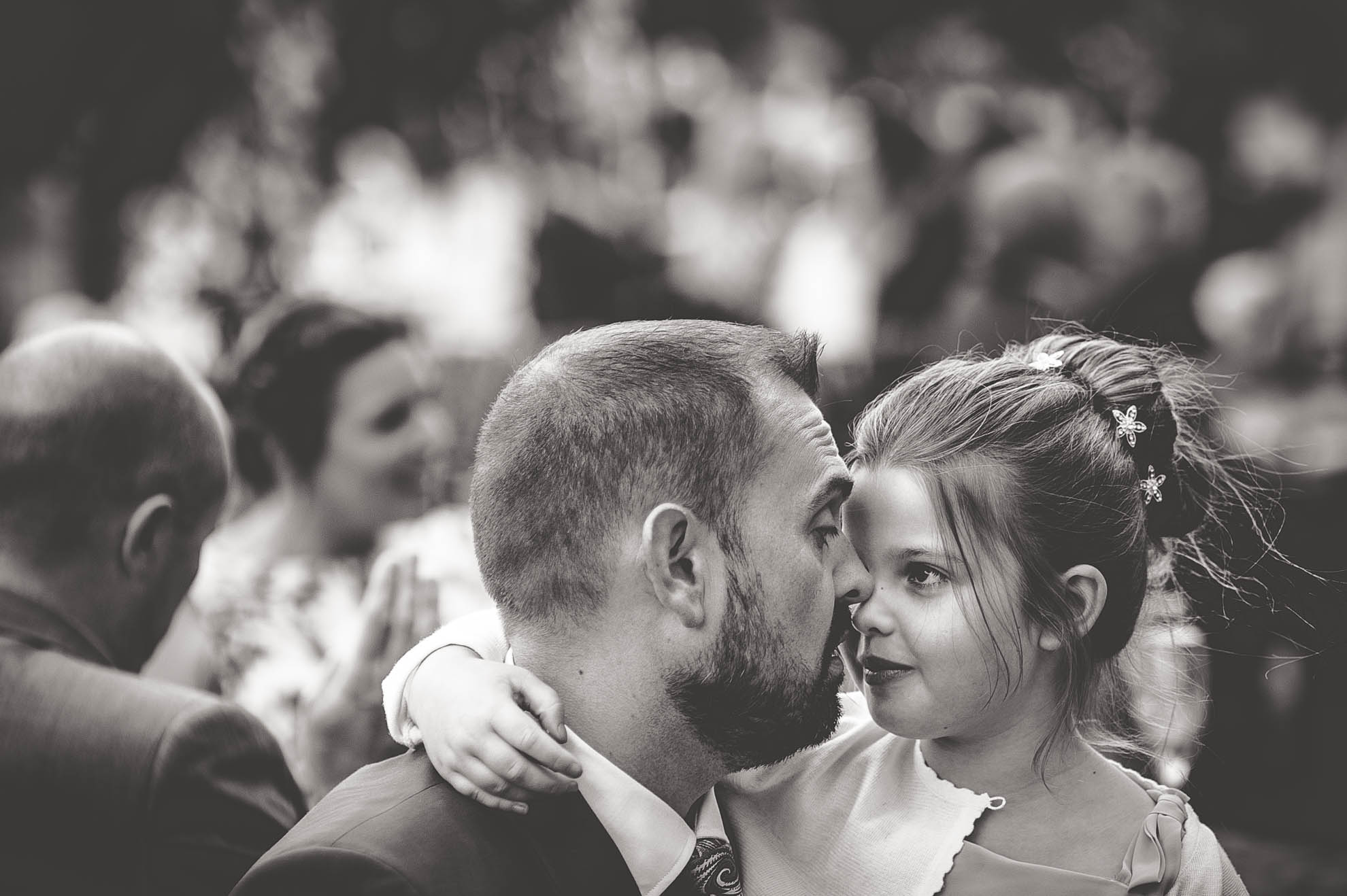 Little girl hugs groom