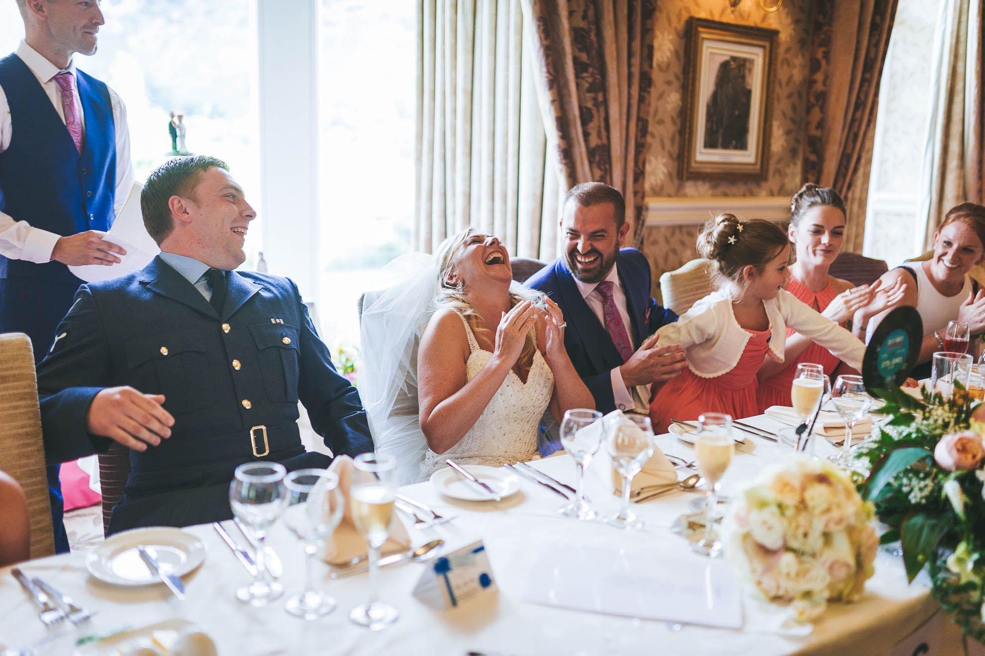 Bride and groom laugh during speeches