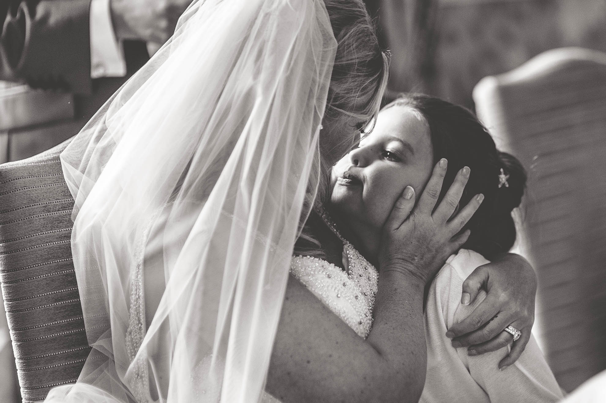 Bride hugs flower girl