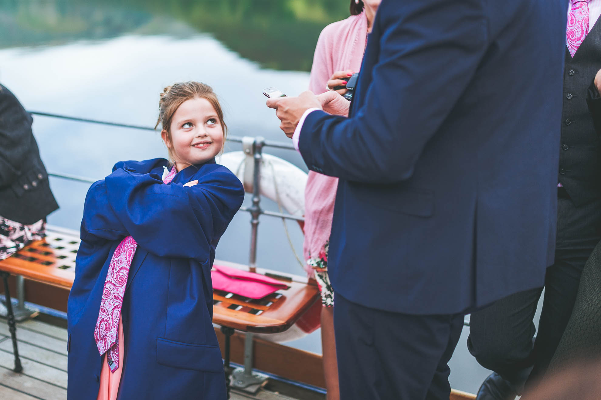 Flower girl wearing mans suit jacket and tie