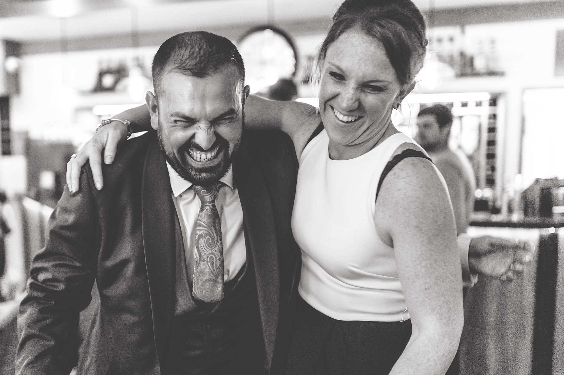 Groom shares a joke with a guest