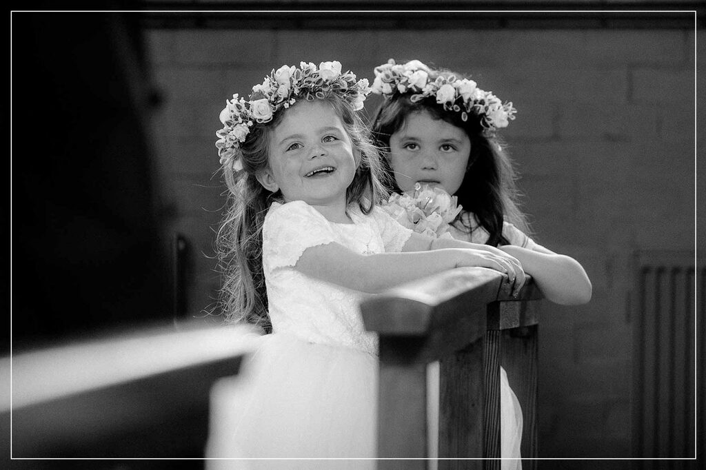 litte girl smailing during wedding ceremony