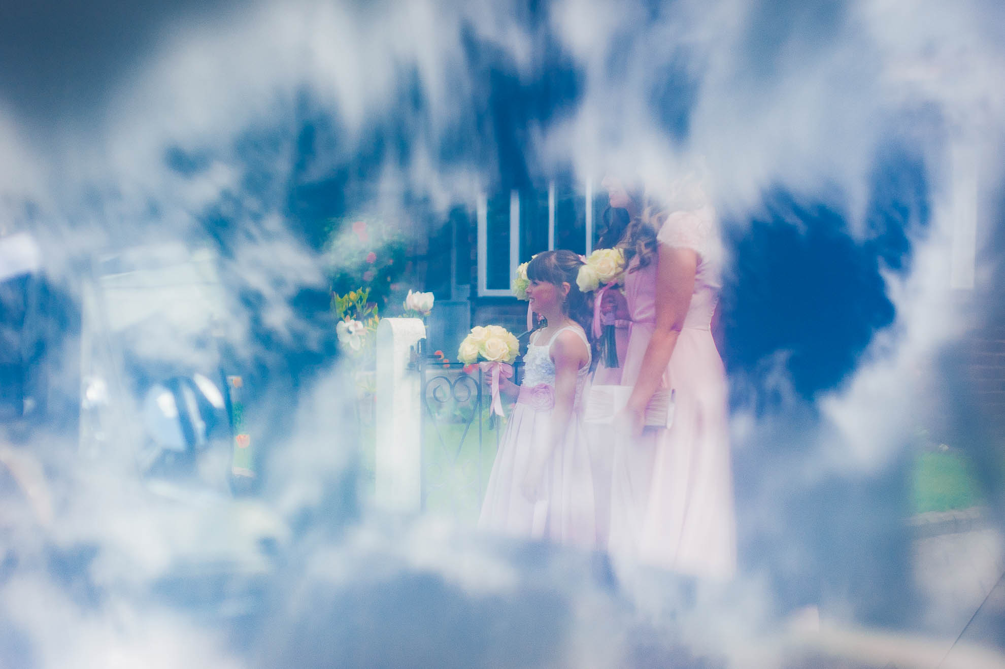 Flower girl waiting to get in wedding car