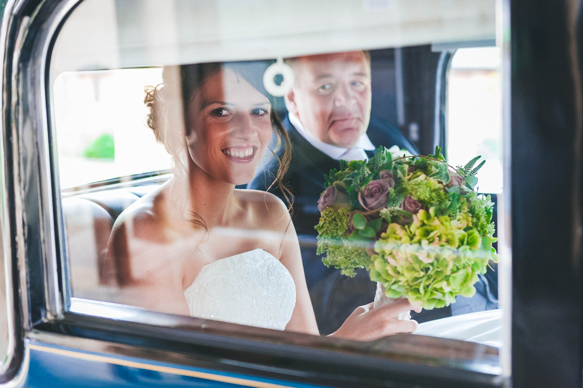 Bride arrives for ceremony in vintage wedding car