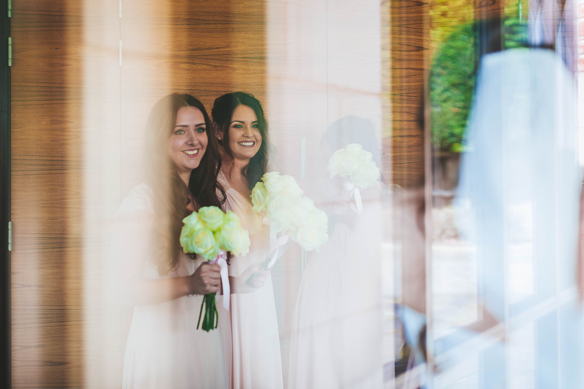 Bridesmaids greet bride as she arrives at Rookery Hall