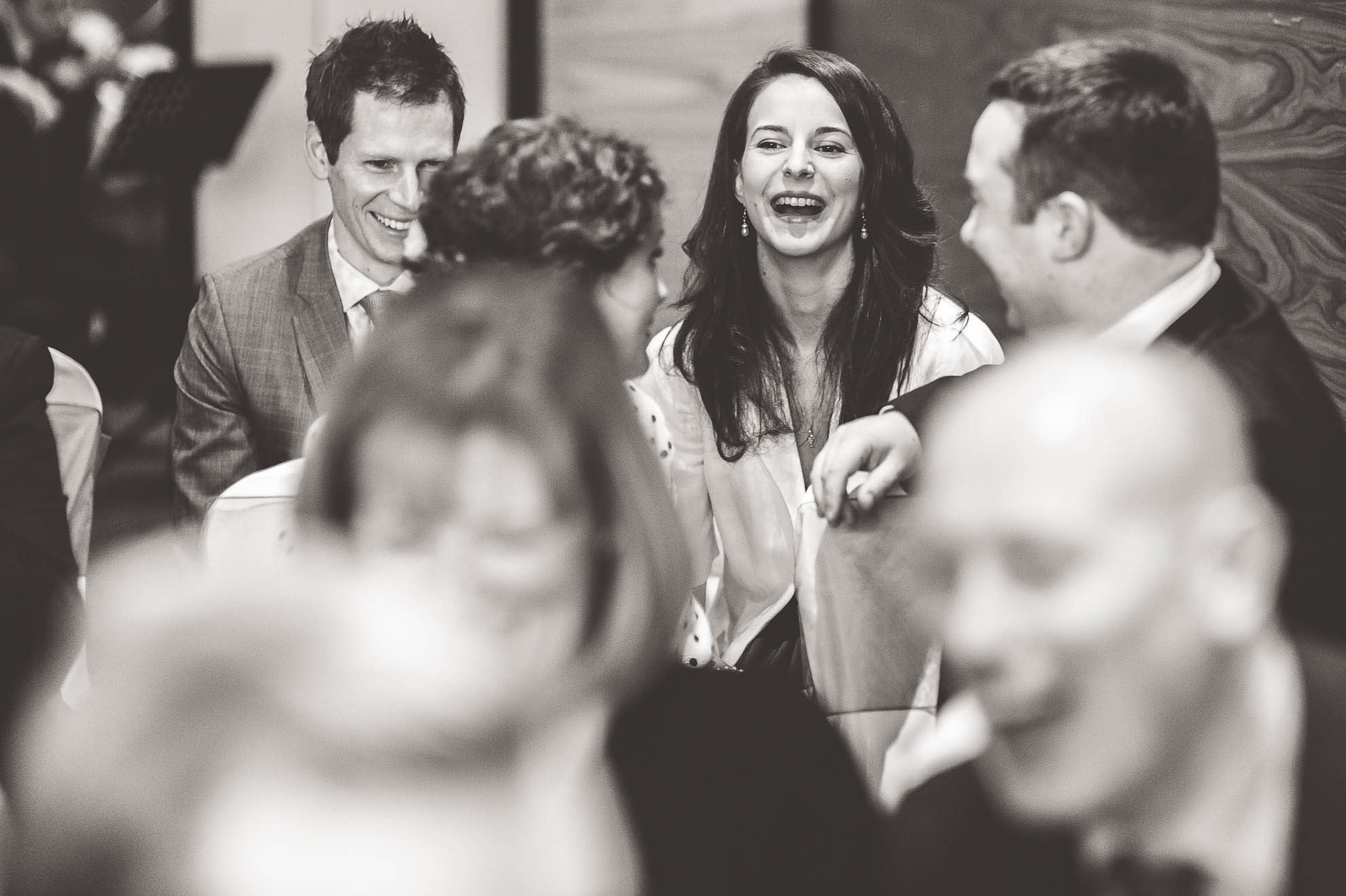 wedding guests sharing a joke before ceremony