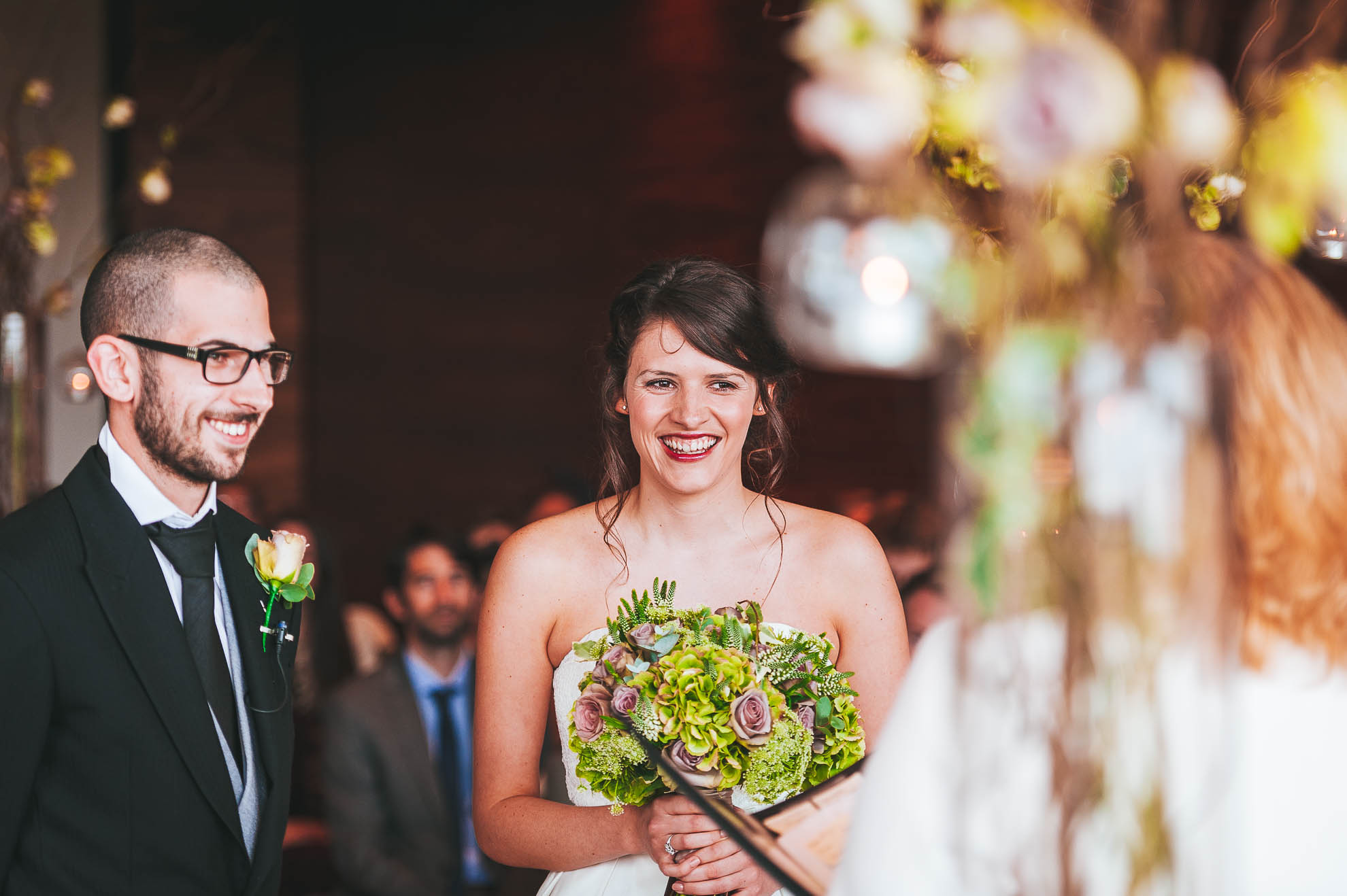 Happy couple share a joke with registrar during ceremony