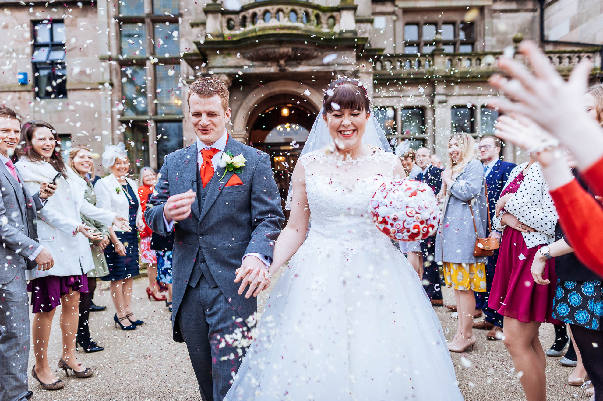 Bride and groom showered with confetti.