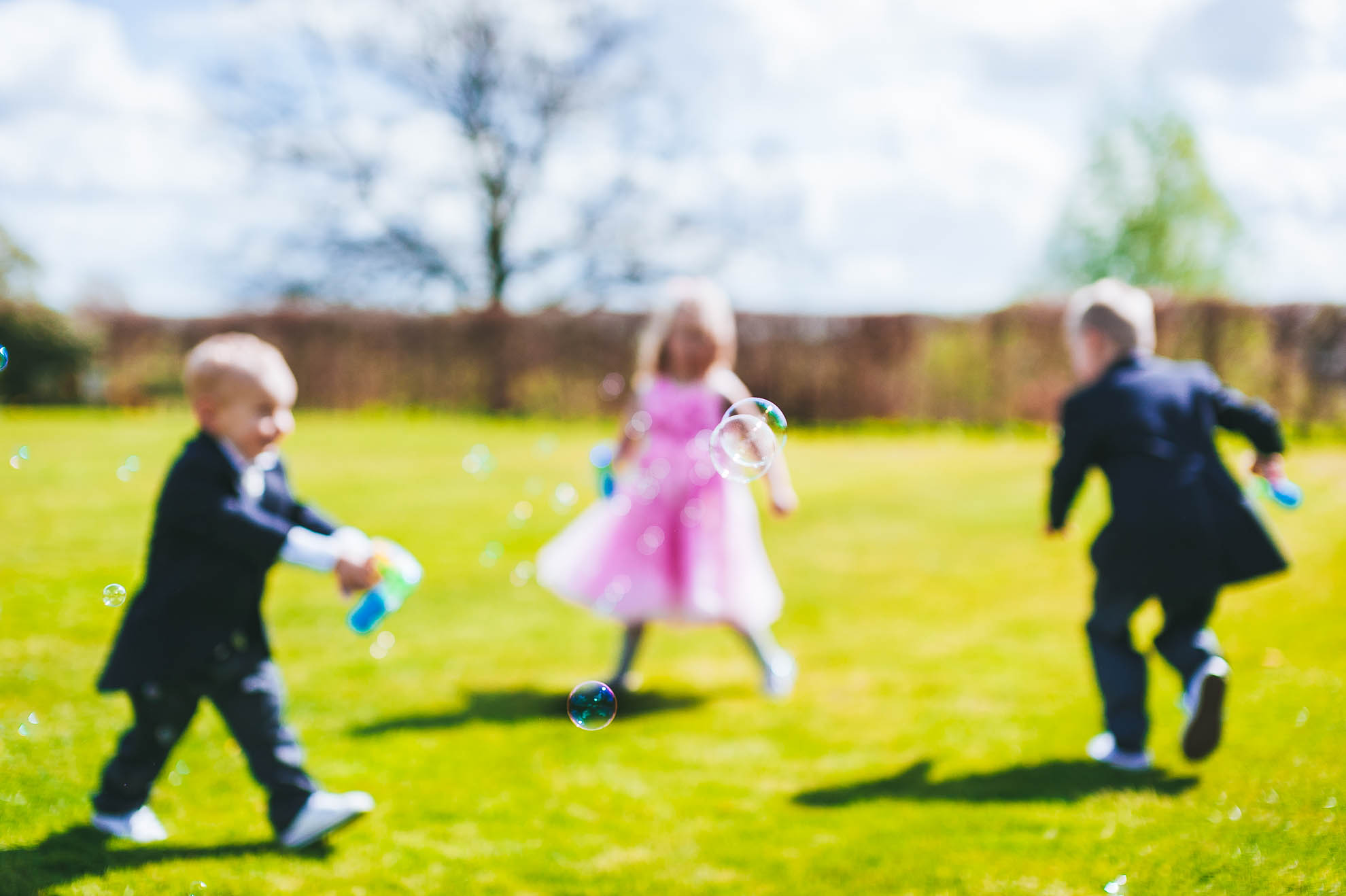 Kids play with bubbles at the wedding