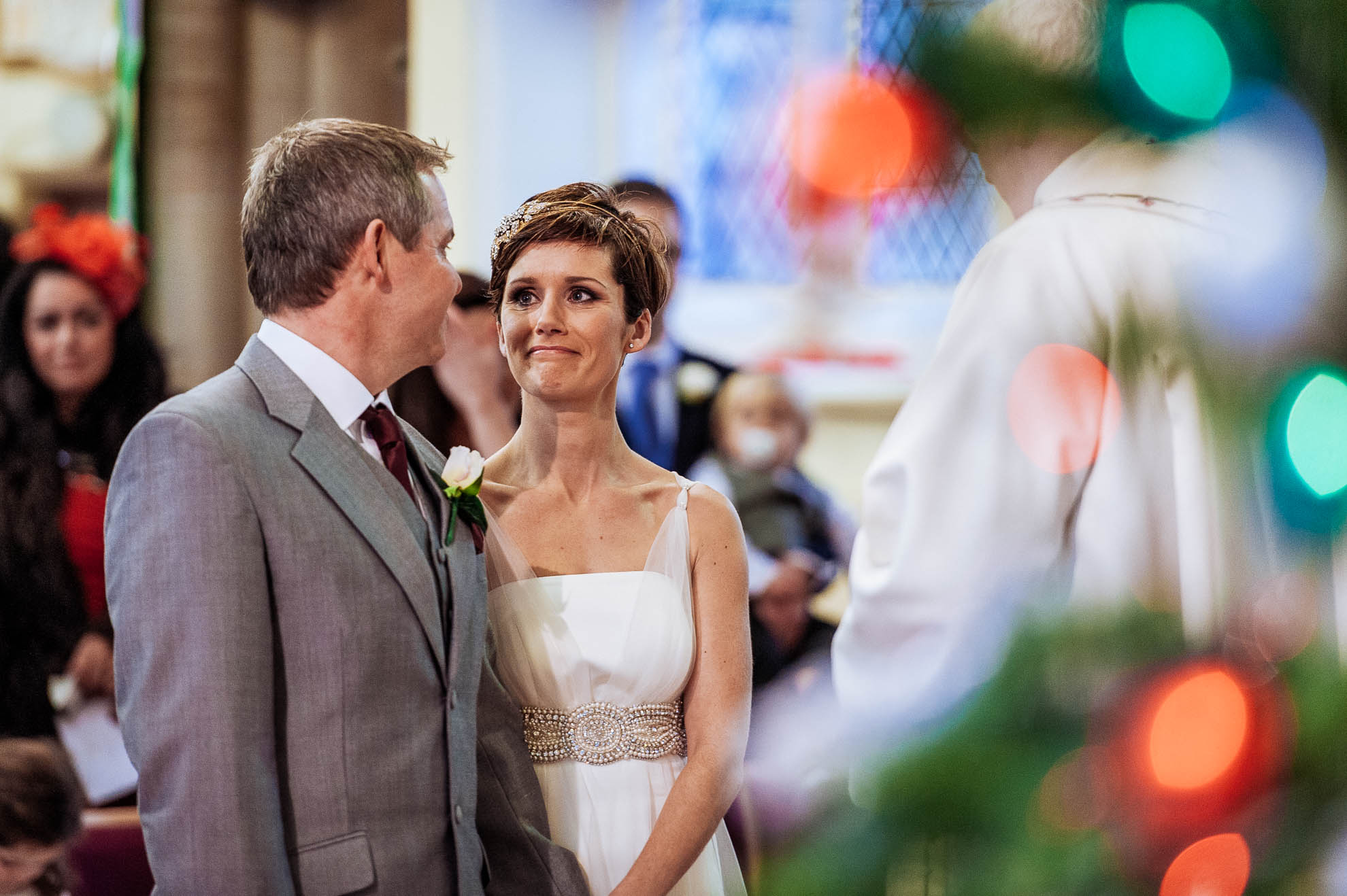 bride smiles at groom during wedding vows